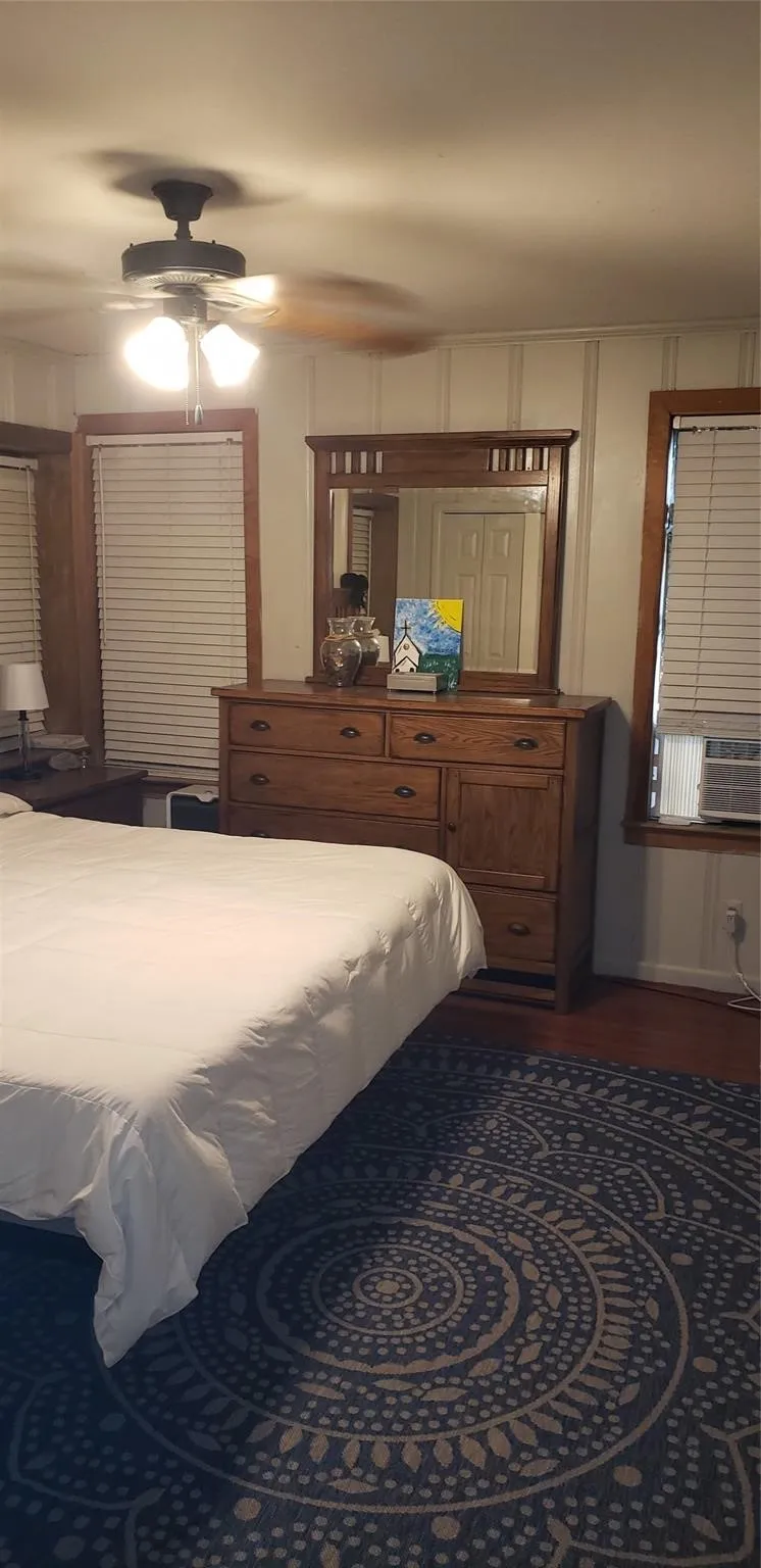 Bedroom featuring ceiling fan and cooling unit