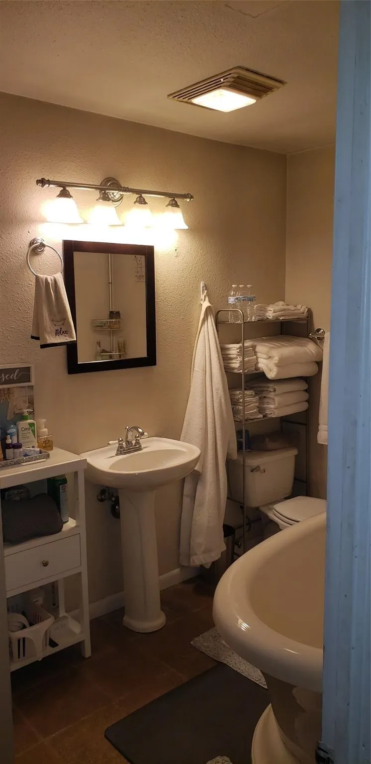 Bathroom with toilet and tile patterned floors