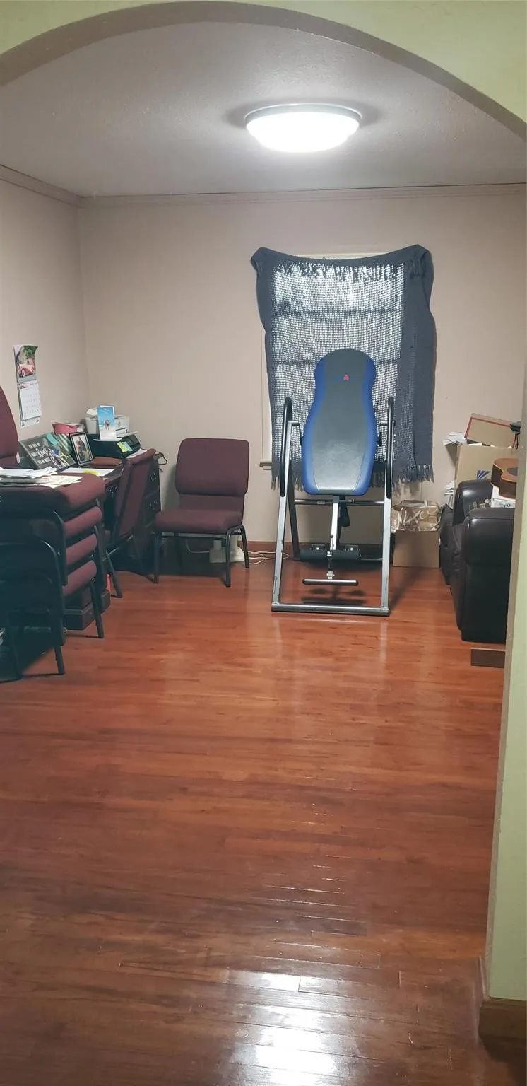 Office space with hardwood / wood-style floors
