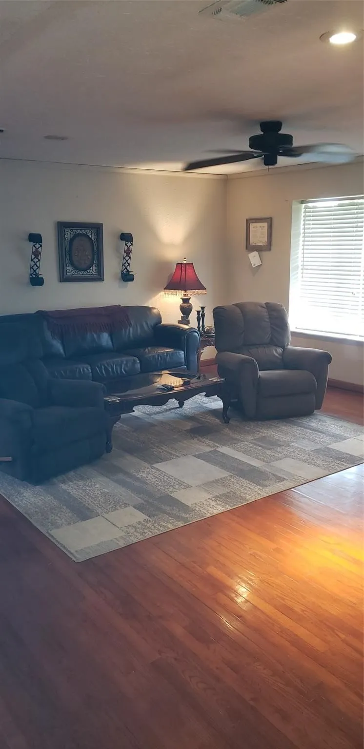 Living room featuring ceiling fan and wood-type​​‌​​​​‌​​‌‌​‌‌​​​‌‌​‌​‌​‌​​​‌​​ flooring