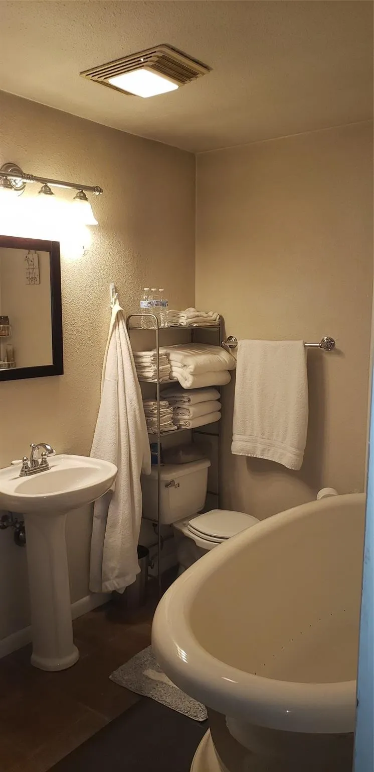 Bathroom with toilet and tile patterned floors