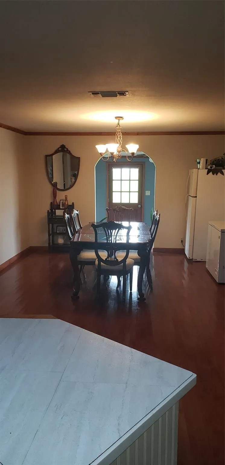 Dining space featuring an inviting chandelier and hardwood / wood-style floors