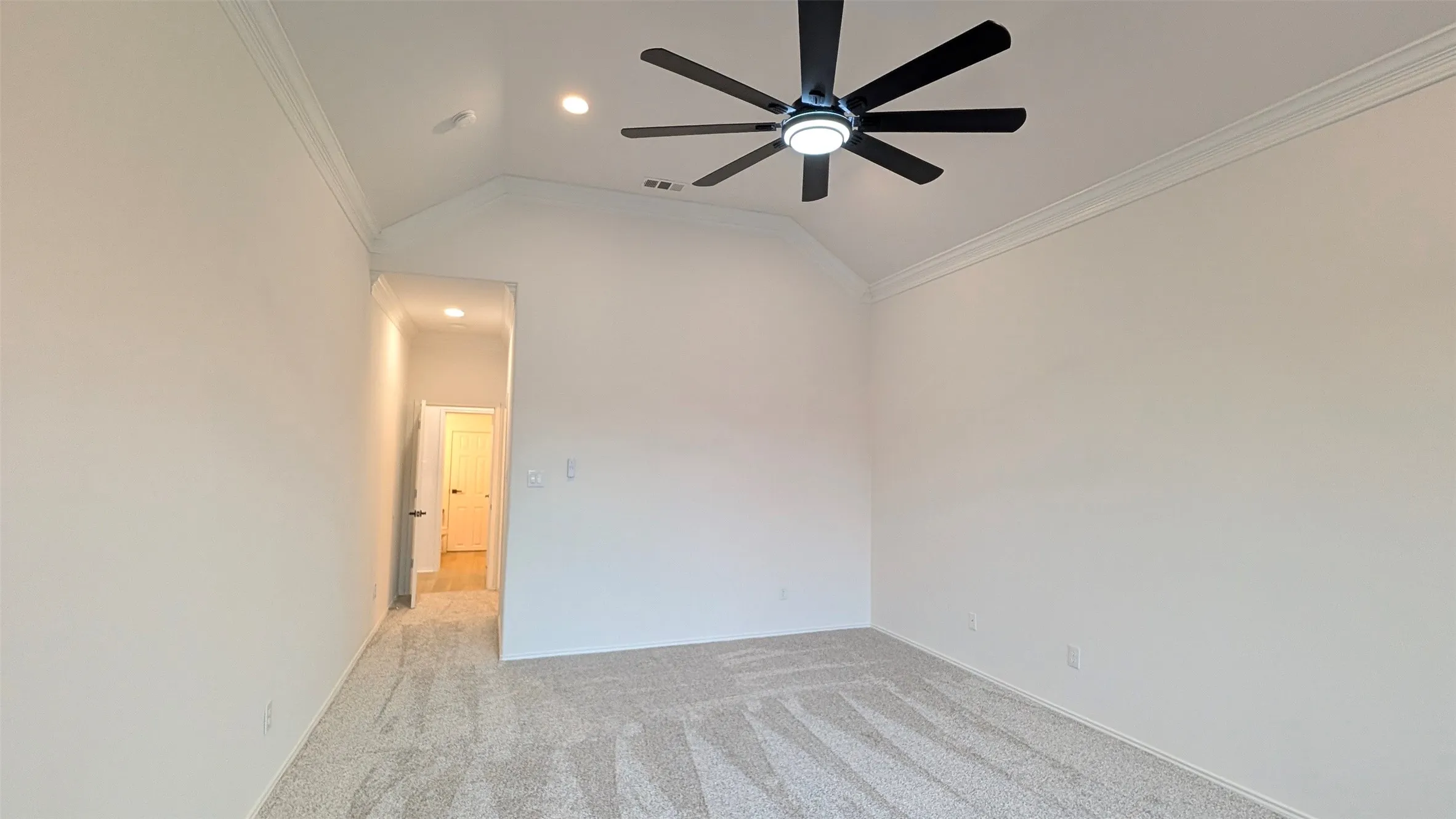 Room featuring vaulted ceilings, crown molding, light-toned carpet flooring, a contemporary ceiling fan, and recessed lighting