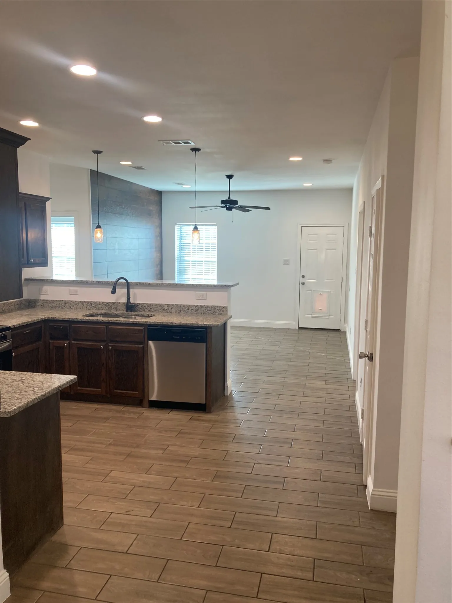 Kitchen and Dining Area from Living Room.  Back Door is in the background.