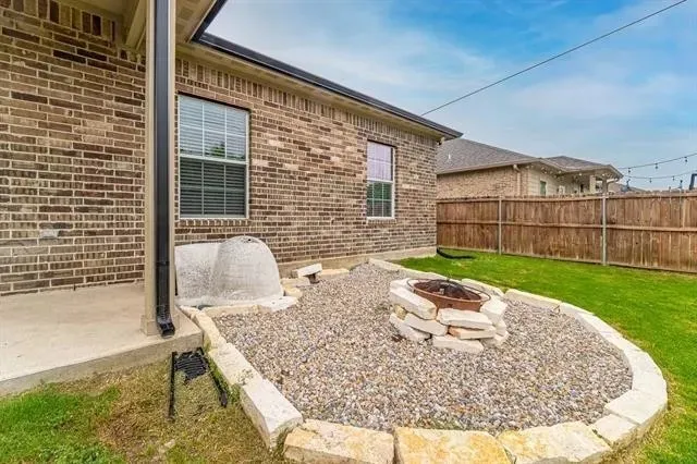 Fire Pit in Back Yard off of the patio.