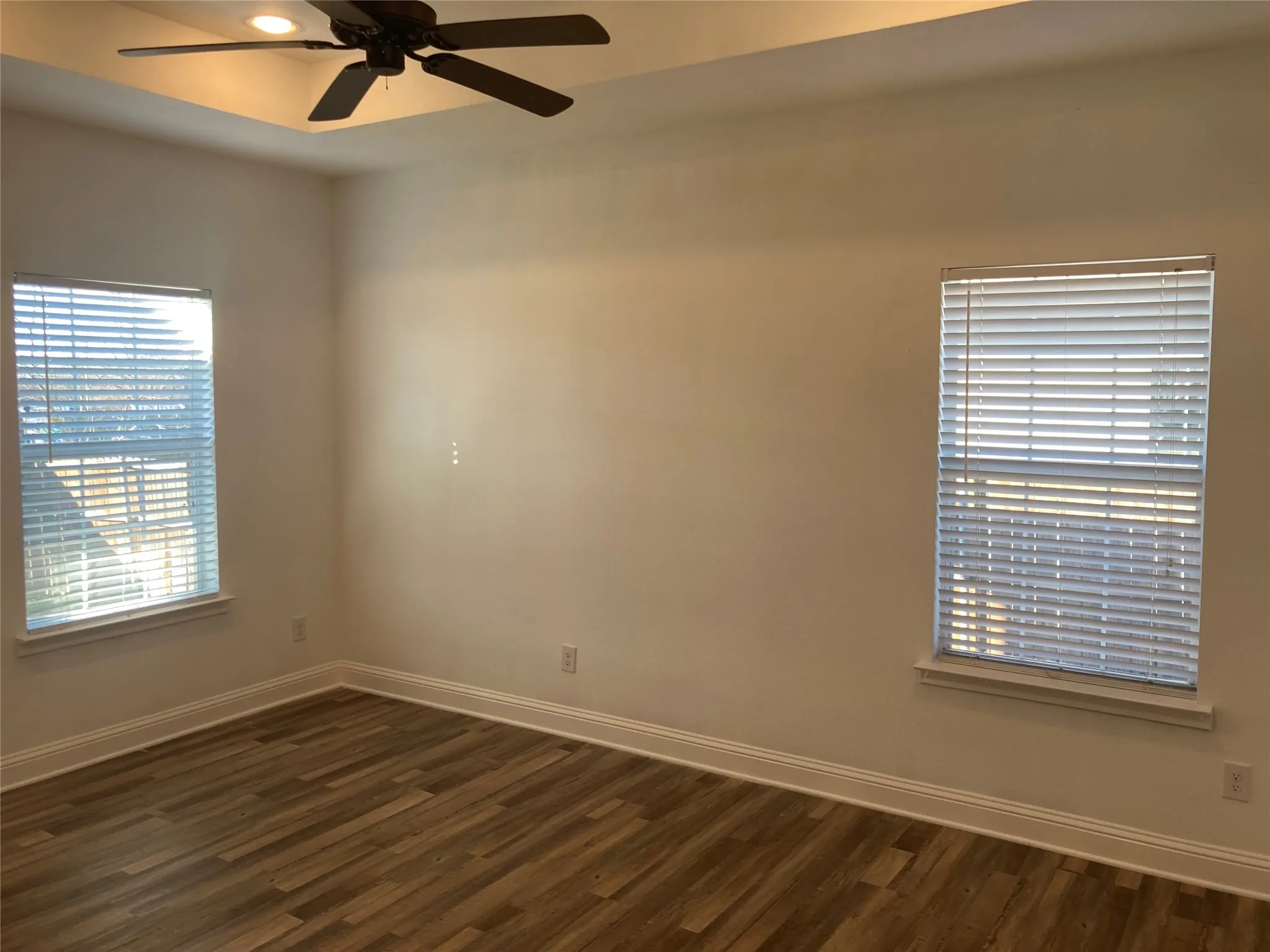 Primary Bedroom features Ensuite, new Vinyl Flooring, Tray Ceiling, and Ceiling Fan.