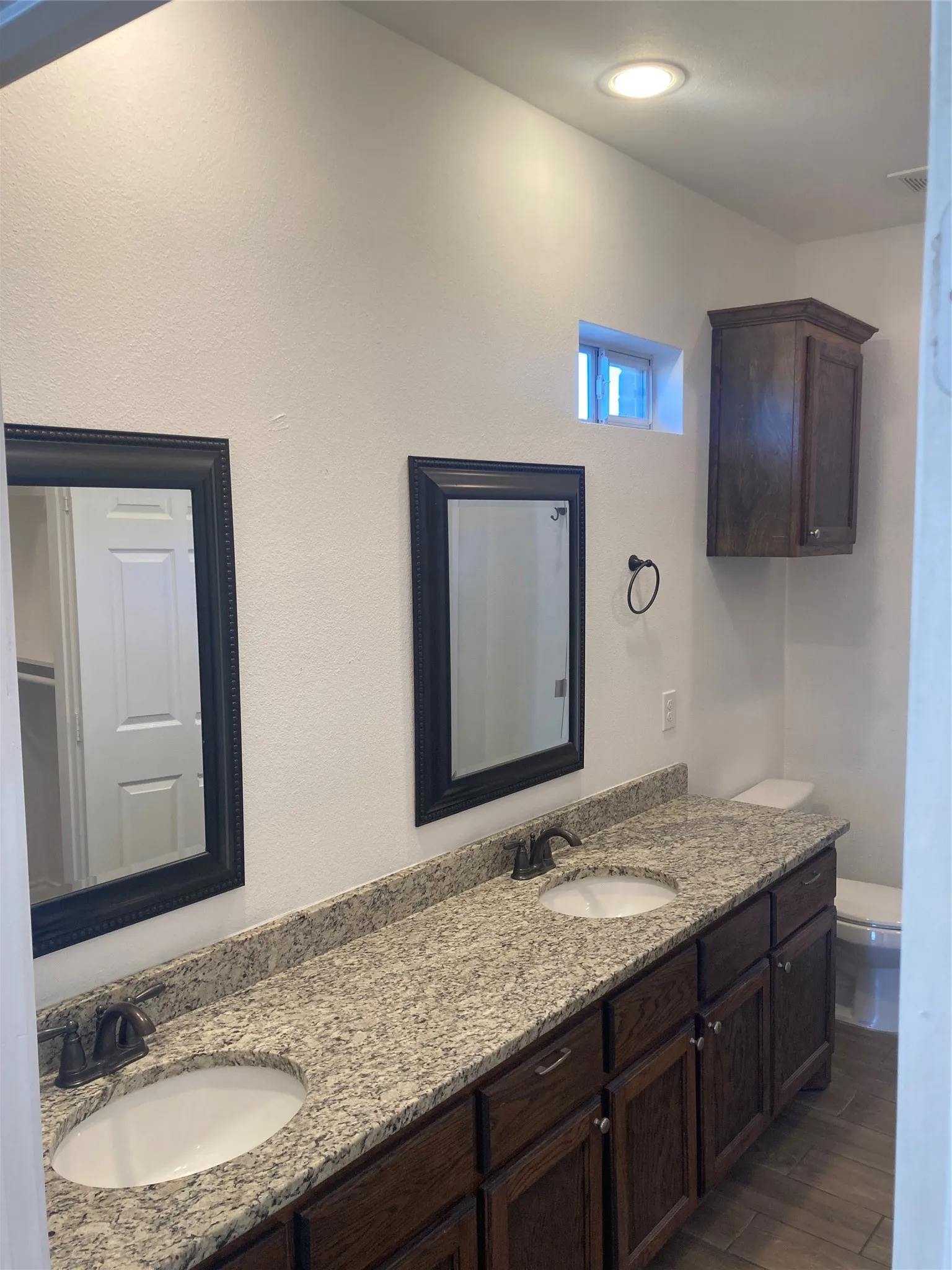 Primary Bathroom has granite countertops and dual vanities.