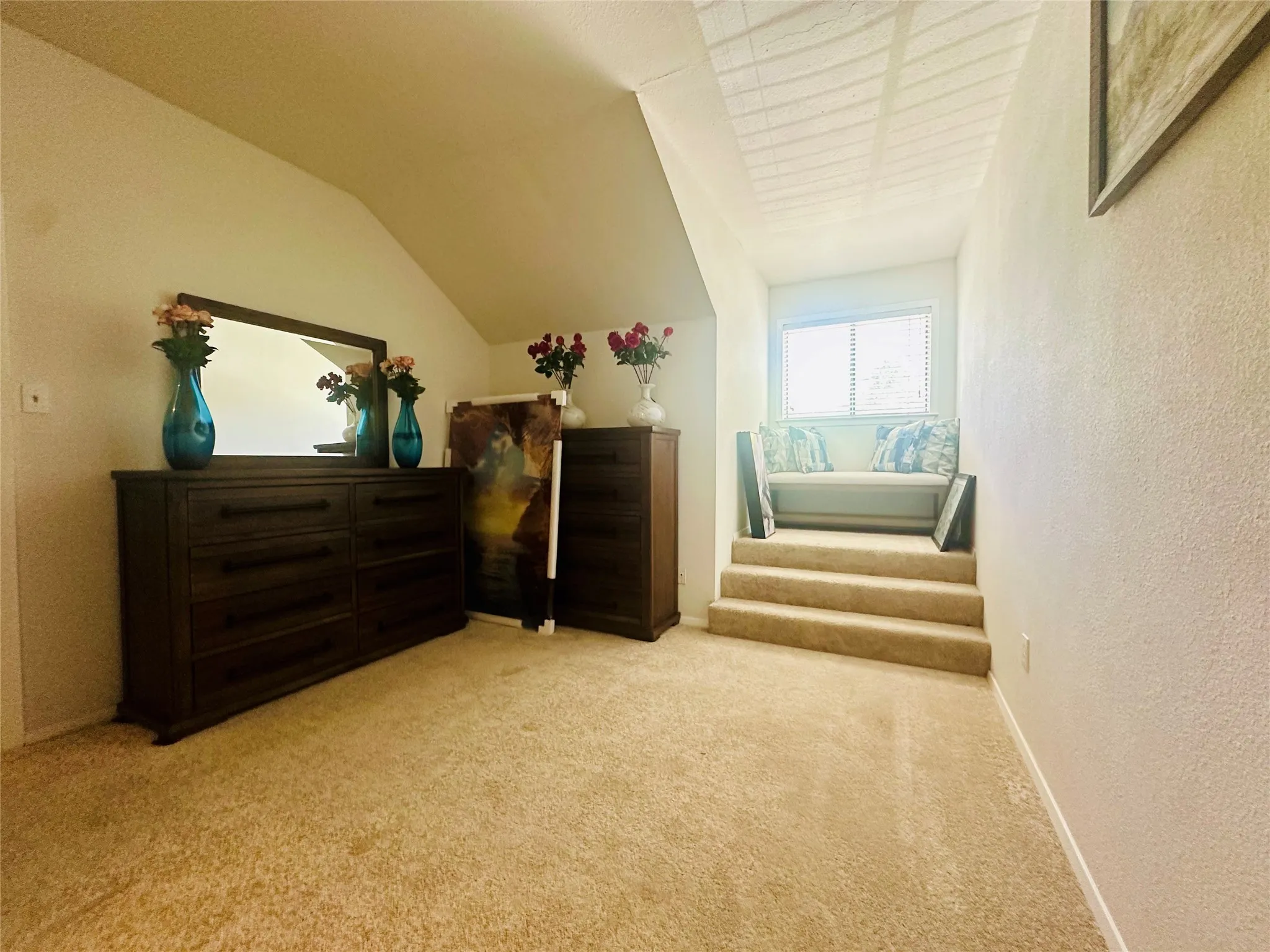 Upstairs secondary bedroom with window nook faces the front of the home