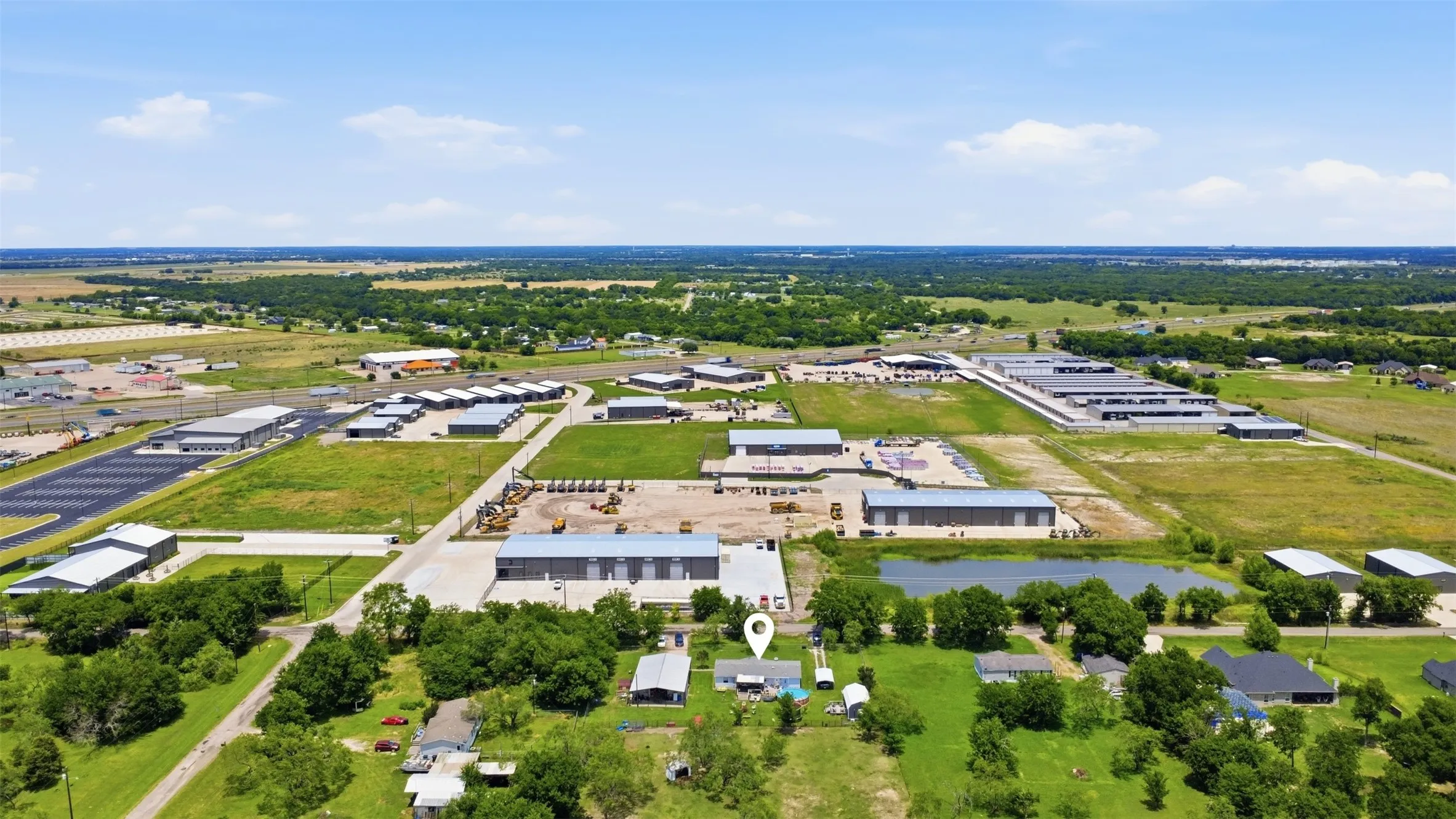 Expansive aerial view showcasing diverse properties amidst green landscapes