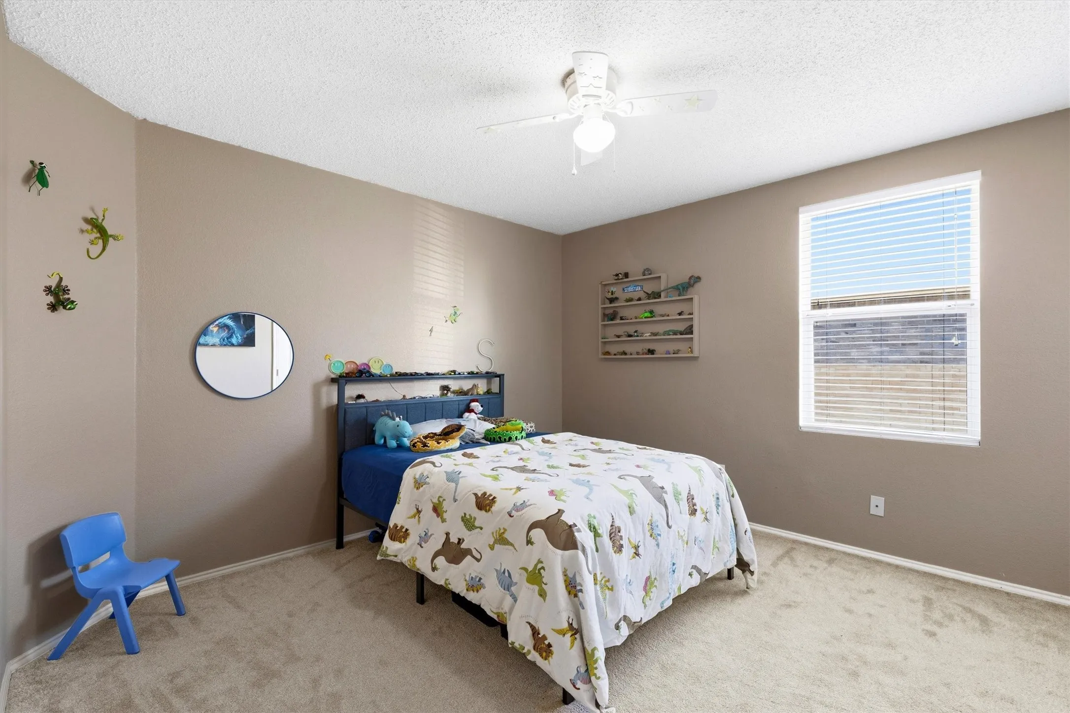 Light brown painted walls and neutral carpeting create a versatile foundation