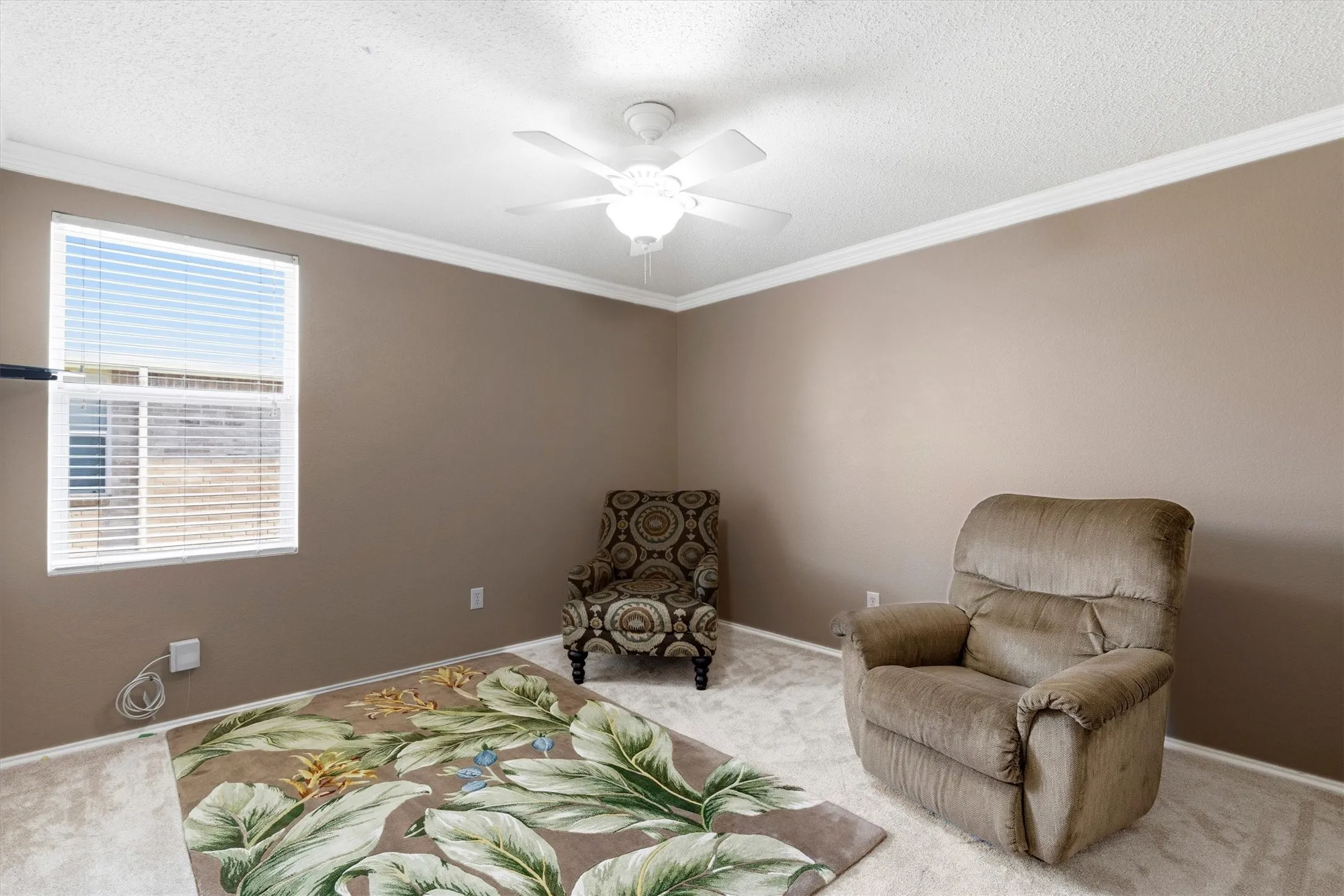 Room featuring carpet flooring, neutral-toned walls, and a window with blinds