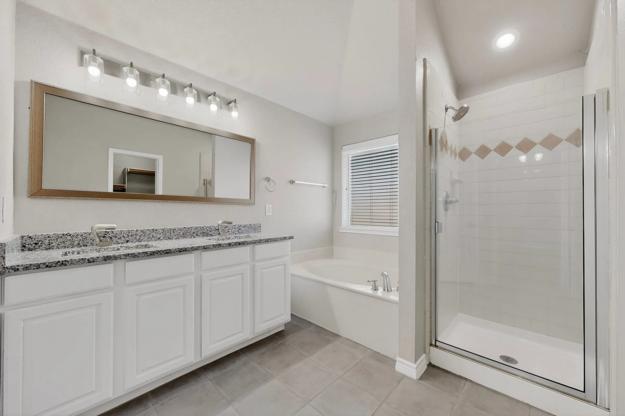 Primary Bathroom with Double Sinks, New Faucets, Granite Countertops and Ceramic Tile Flooring