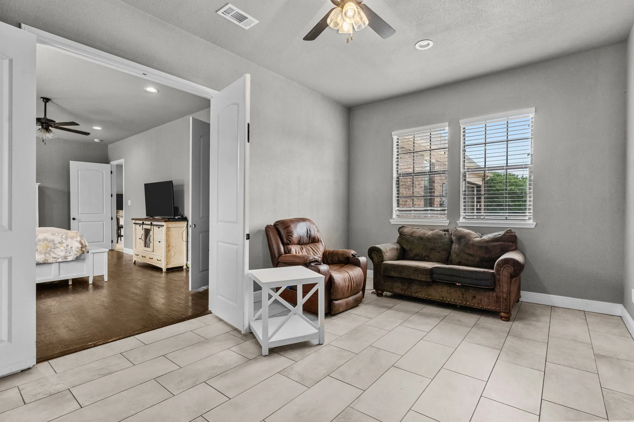 Living room with ceiling fan and light wood-type flooring