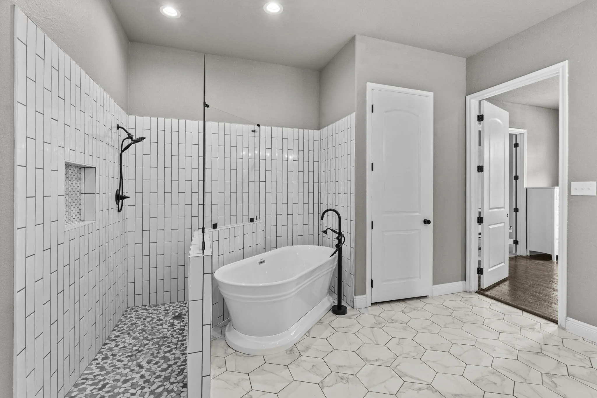 Bathroom with independent shower and bath and tile patterned floors
