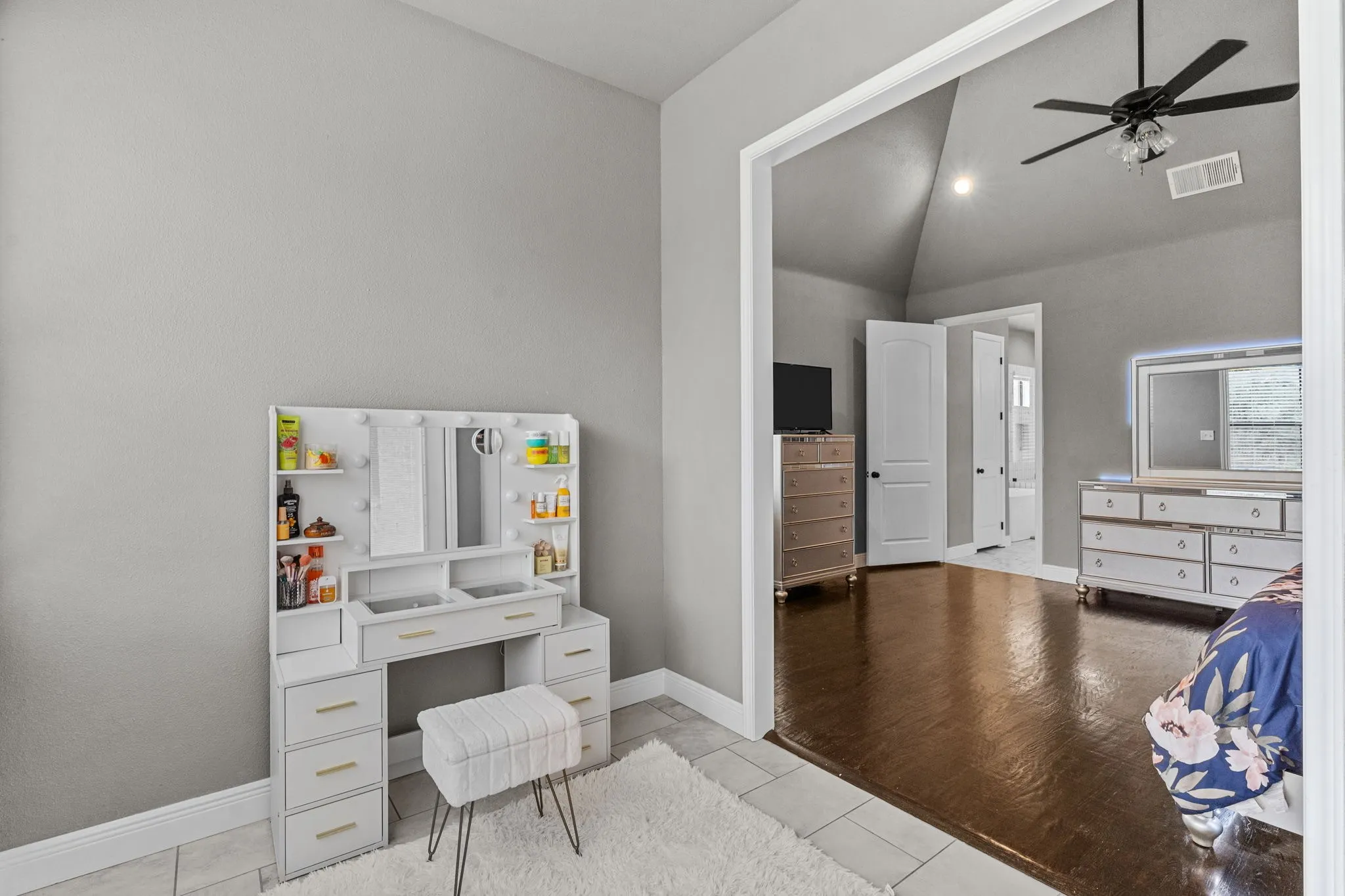 Office space featuring vaulted ceiling, light wood-type flooring, and ceiling fan