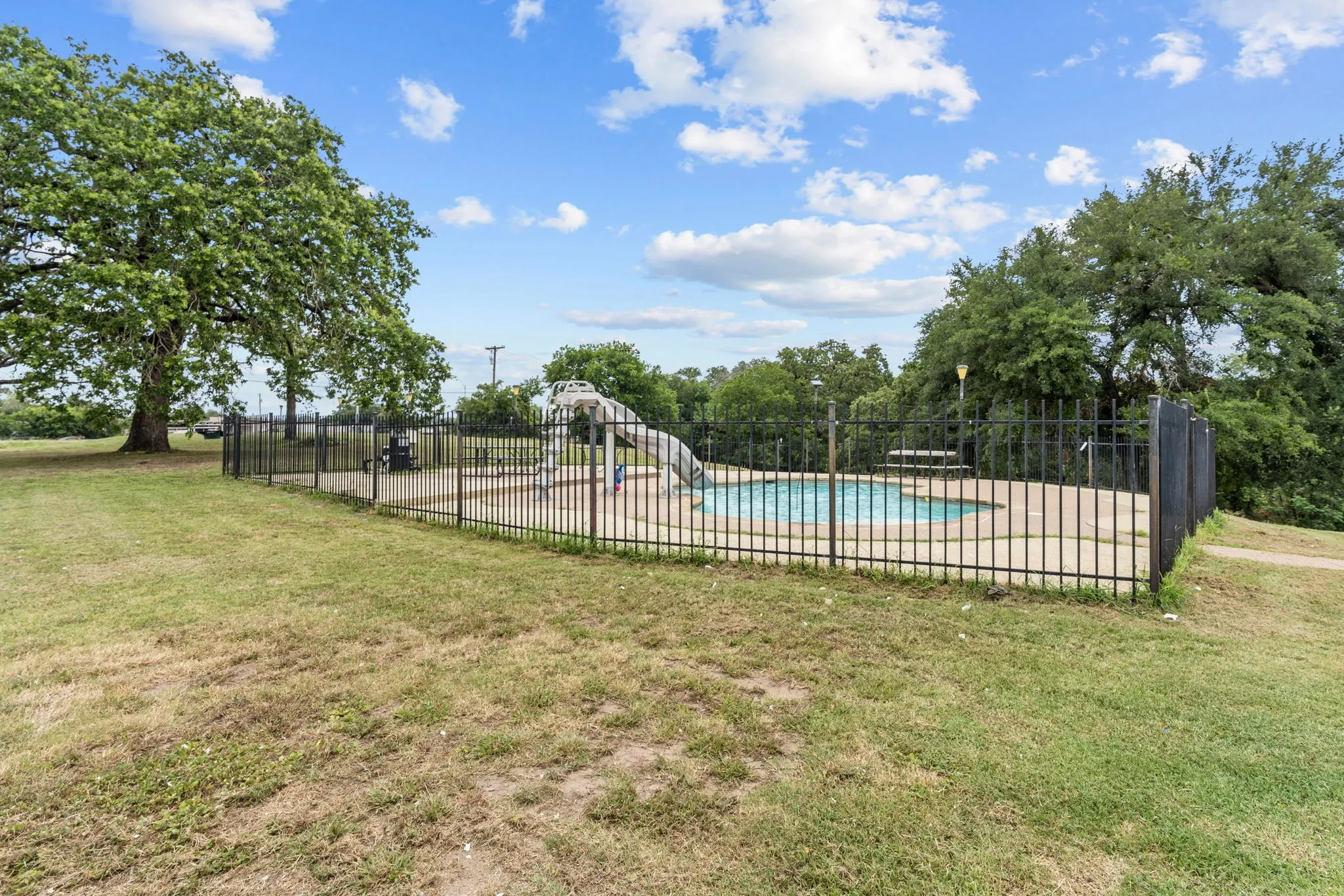 View of swimming pool with a lawn