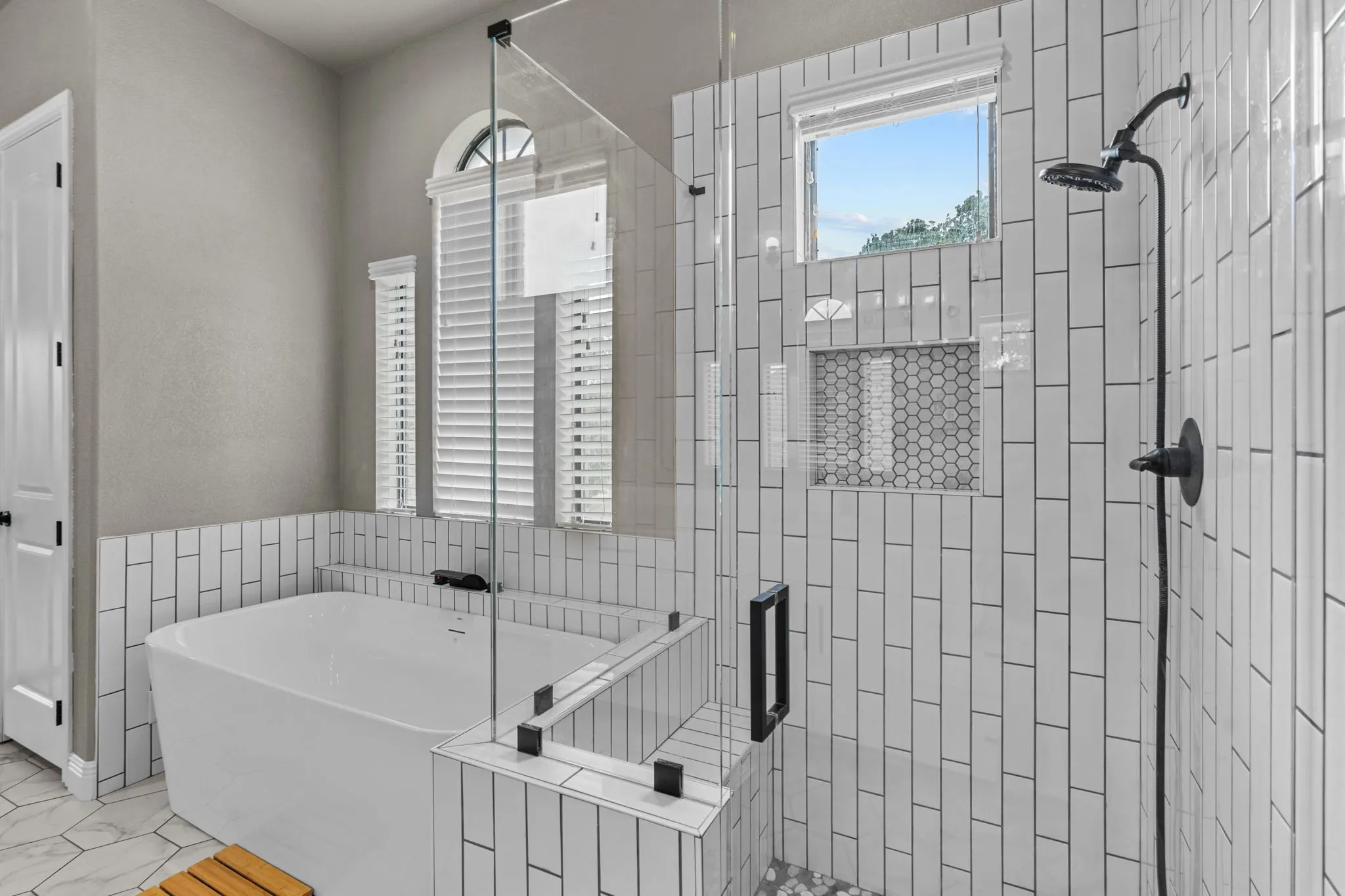 Bathroom featuring tile patterned flooring and separate shower and tub