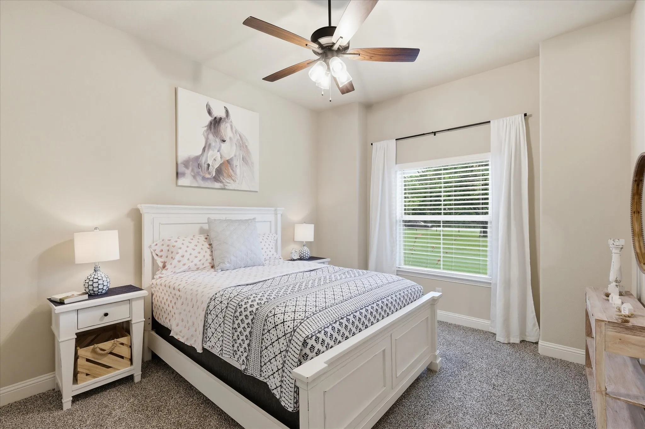 Bedroom featuring neutral wall tones, textured carpeting, a ceiling fan with light fixture, and a window with blinds and drapes