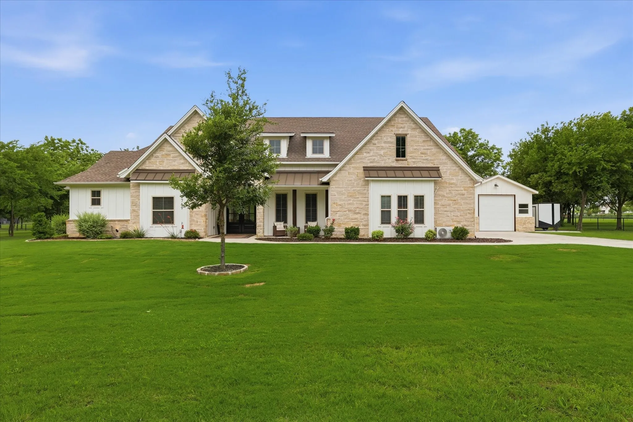 Stone and white board-and-batten exterior with dark trim accents