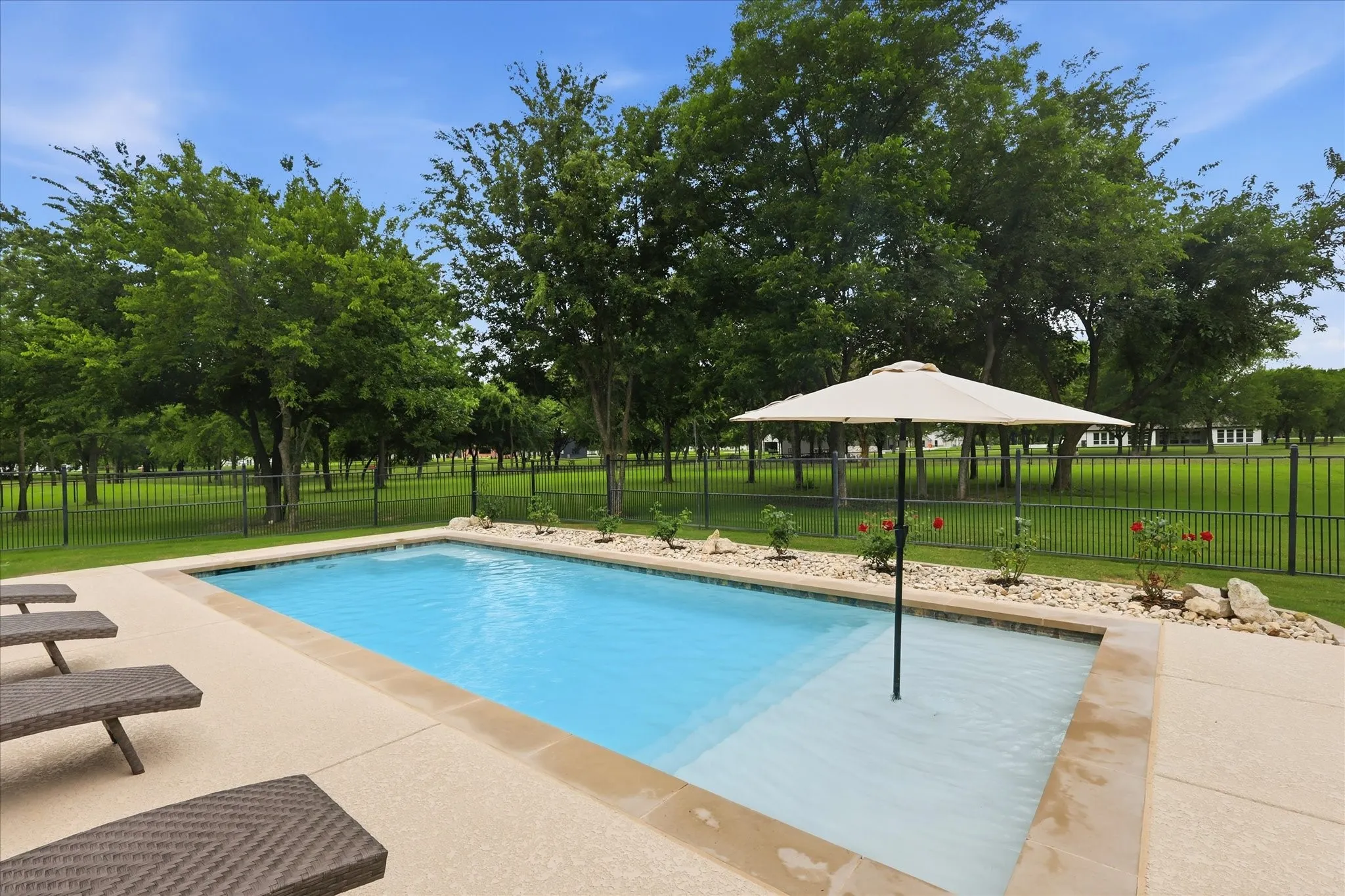In-ground swimming pool with a sun shelf
