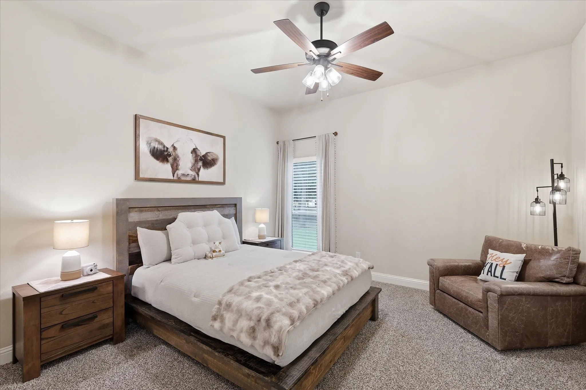 Bedroom featuring neutral wall colors, carpet flooring, a ceiling fan with light fixture, and a window with horizontal blinds