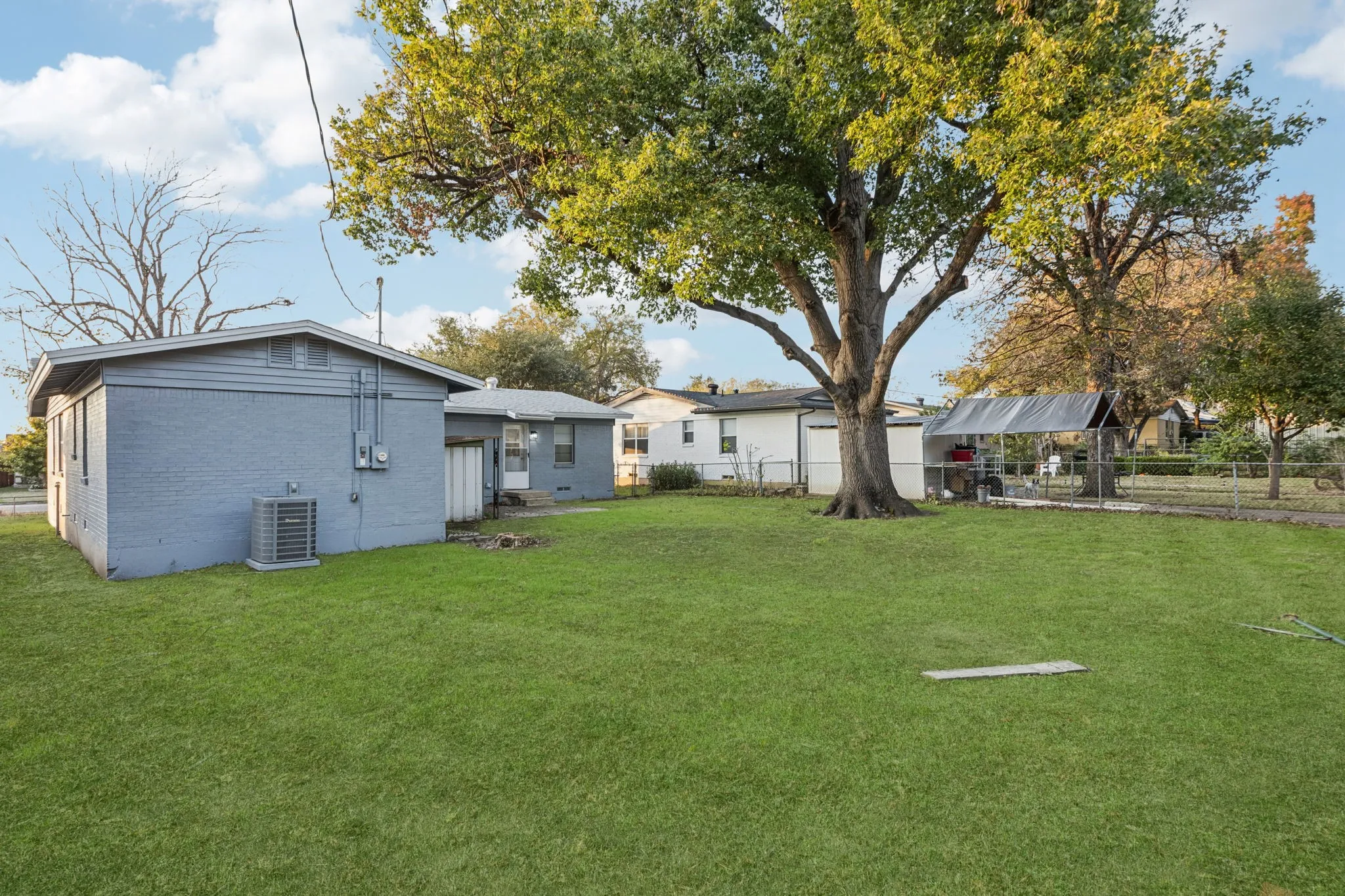 Large backyard with a storage shed