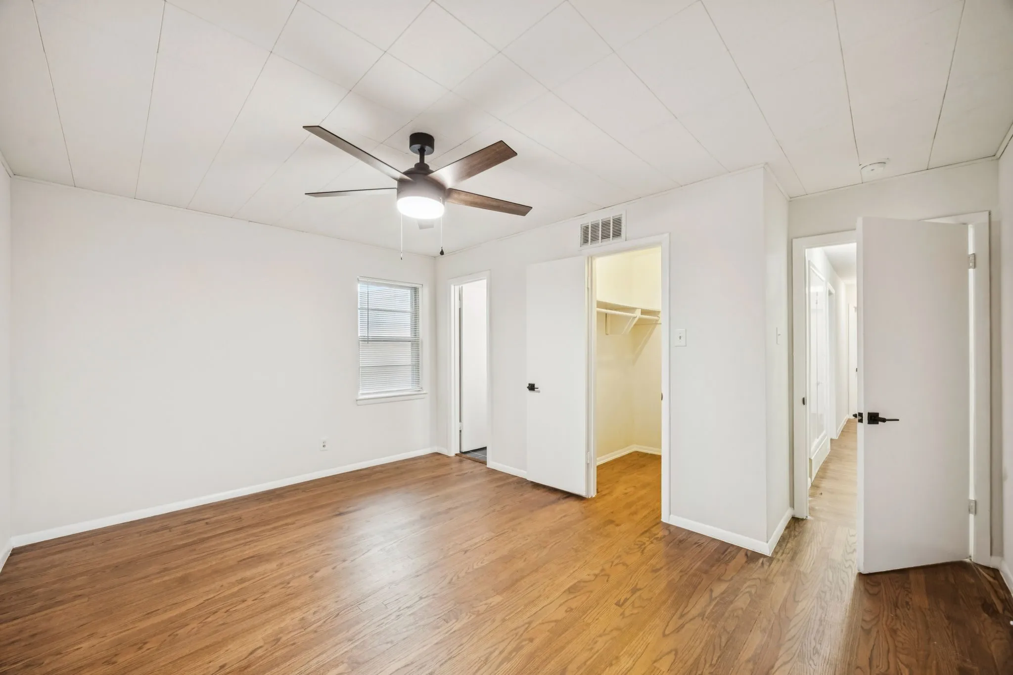 Primary bedroom with walk-in closet and ensuite bath