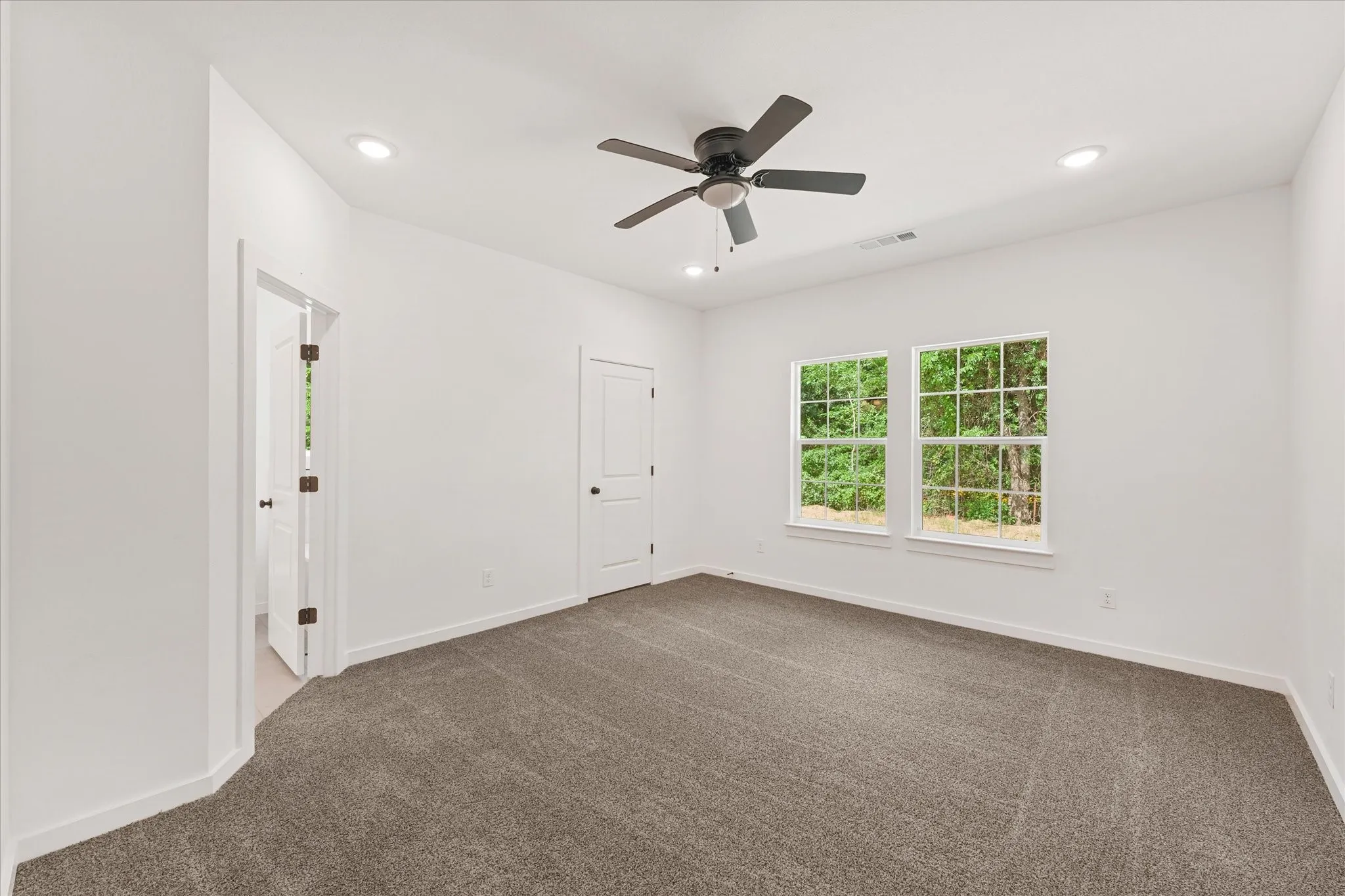 Room featuring plush carpet flooring, recessed lighting, and a ceiling fan with integrated light fixture