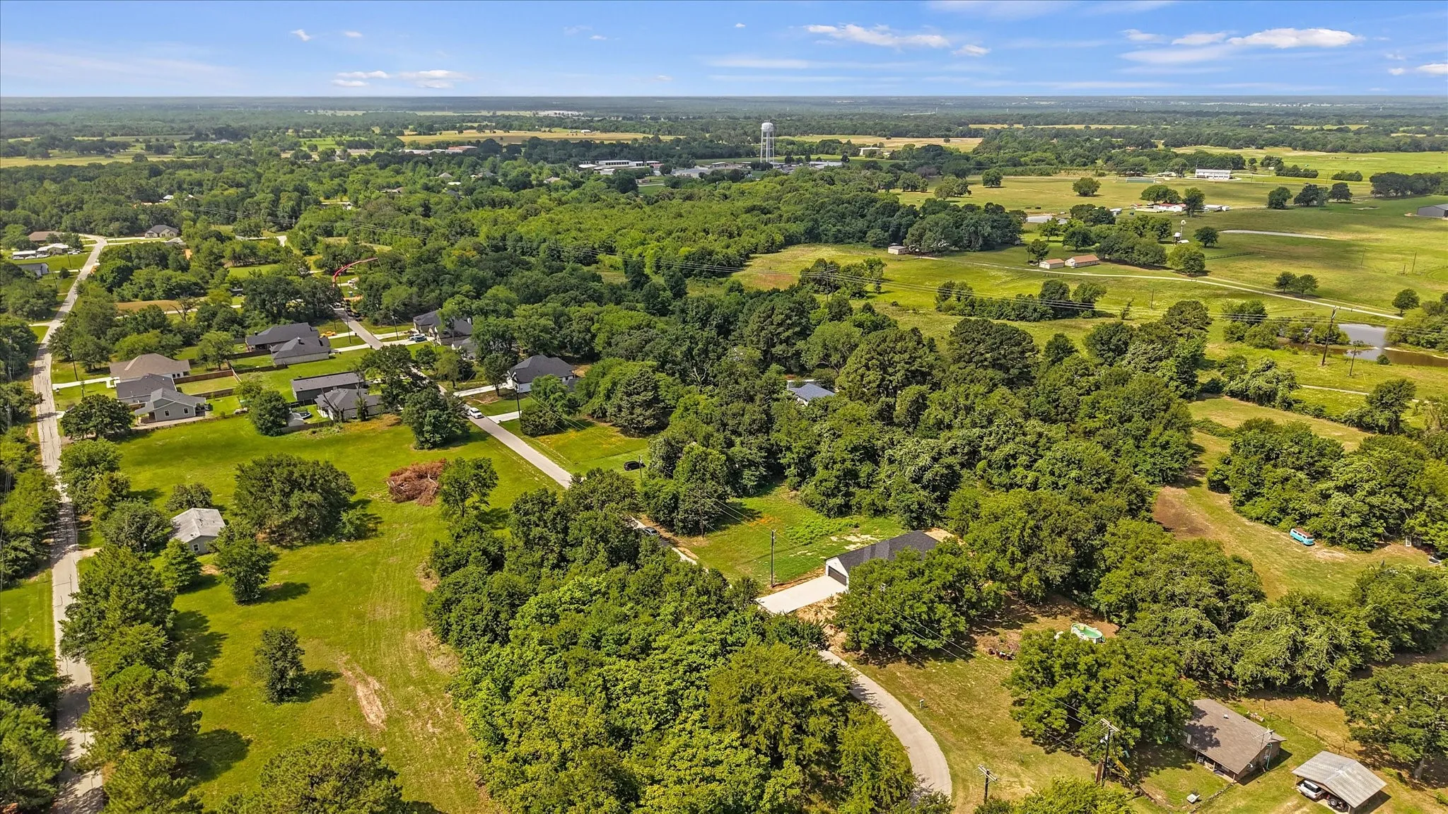 Expansive aerial perspective showcasing a verdant landscape with mature trees and open green spaces