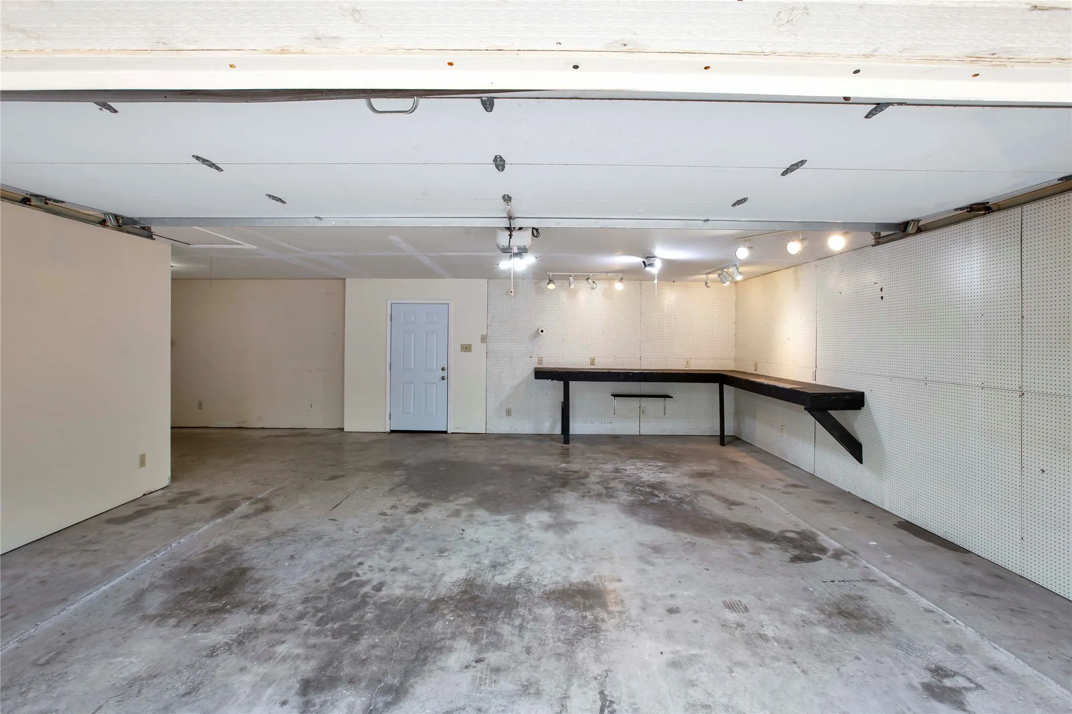 View From Front Into Garage wWork Bench, Ofc Entry Is To The Left & Back Door Into Fenced Back Yard.