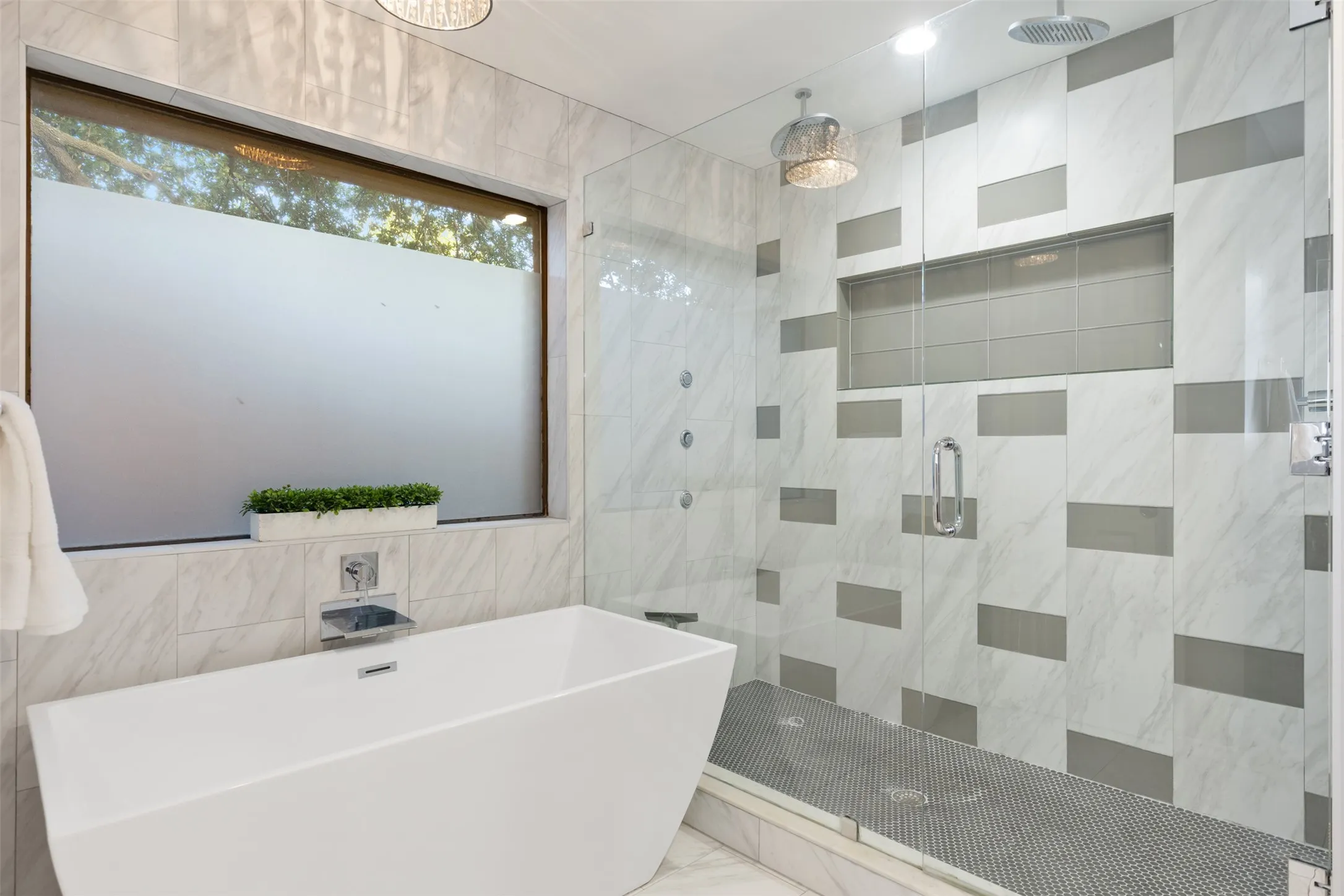 Spacious primary shower with stand alone tub.
