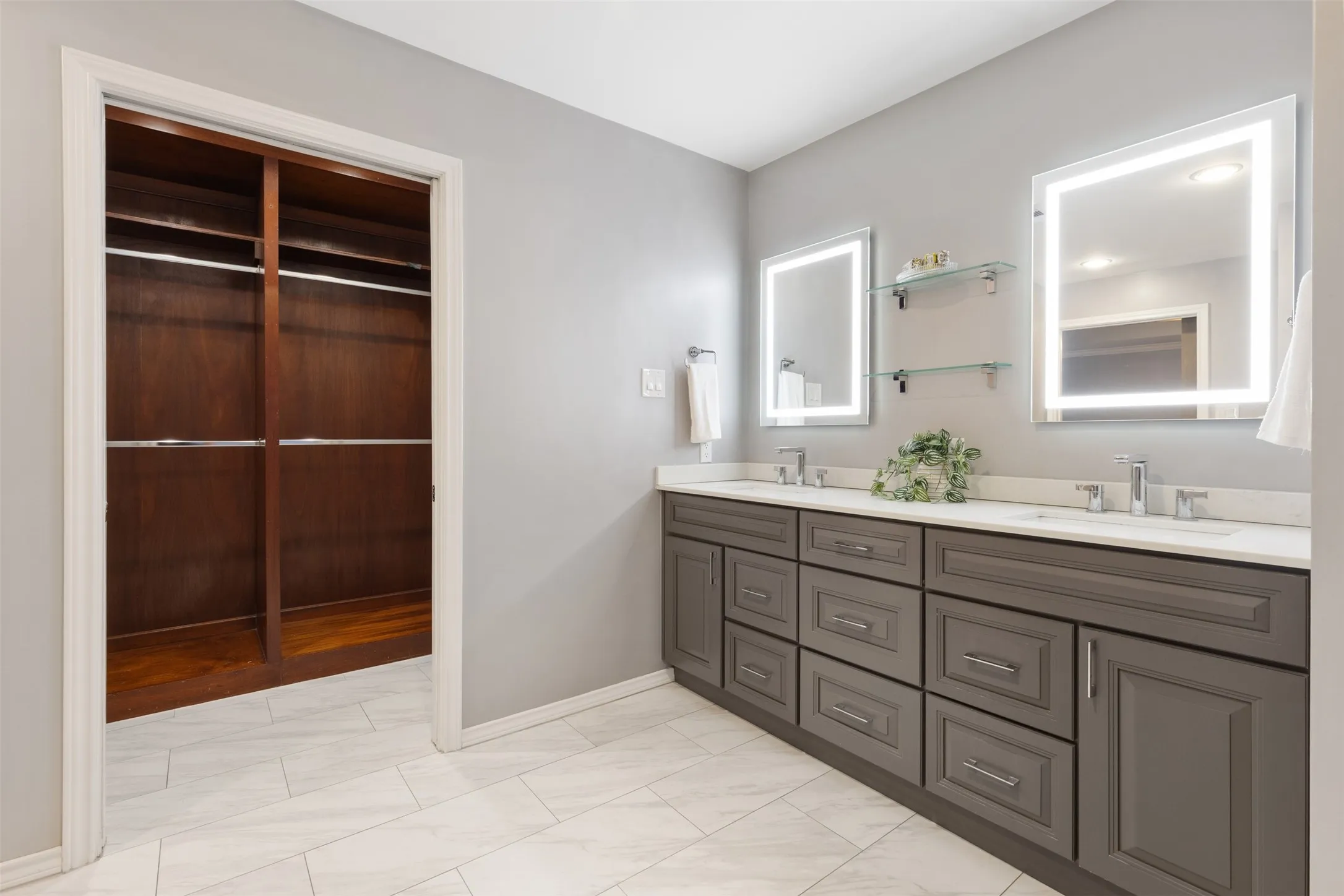 Updated master bath with view of walk-in closet, pocket doors.