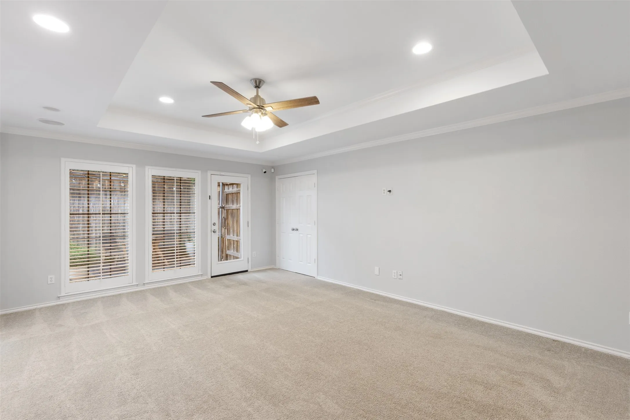 View from game room to side yard garden with exterior door.