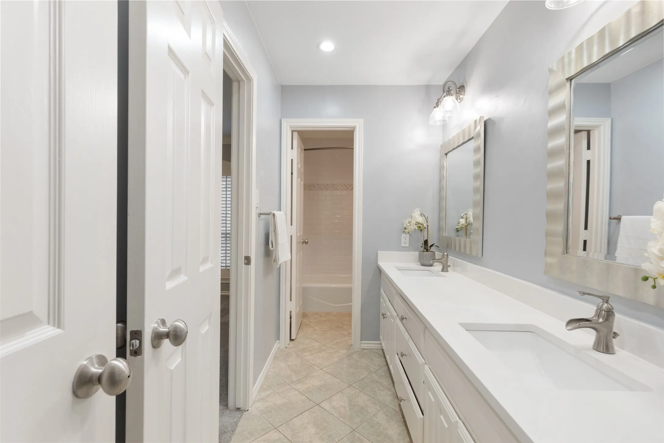 Jack and Jill bathroom. Tub and shower with two separate sinks.