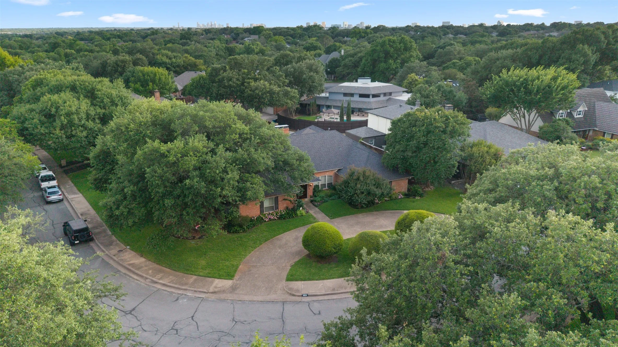 Oversized landscaped corner lot with mature trees, and circular drive way.