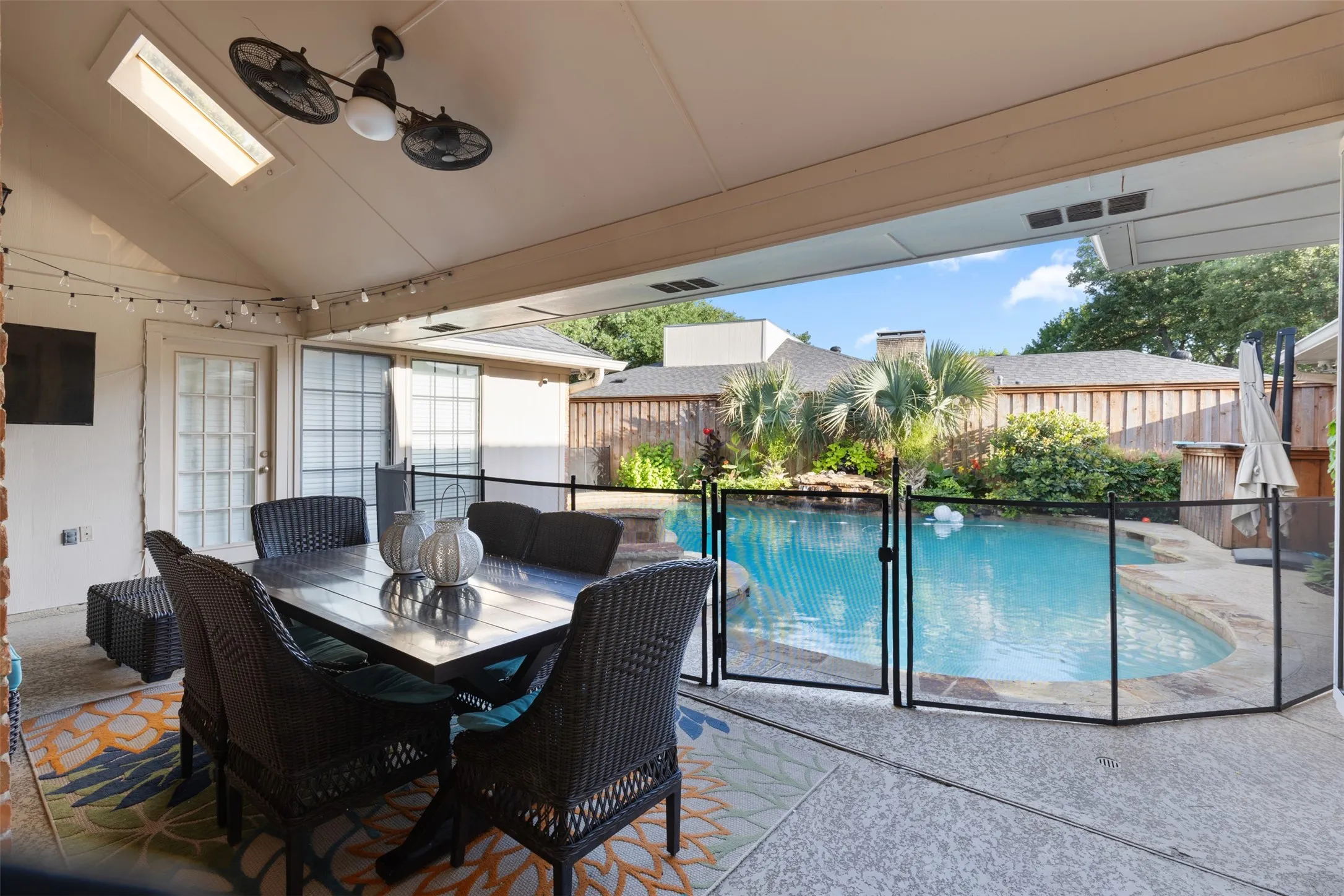 View from back patio to fully safety fenced pool. Removable fencing.