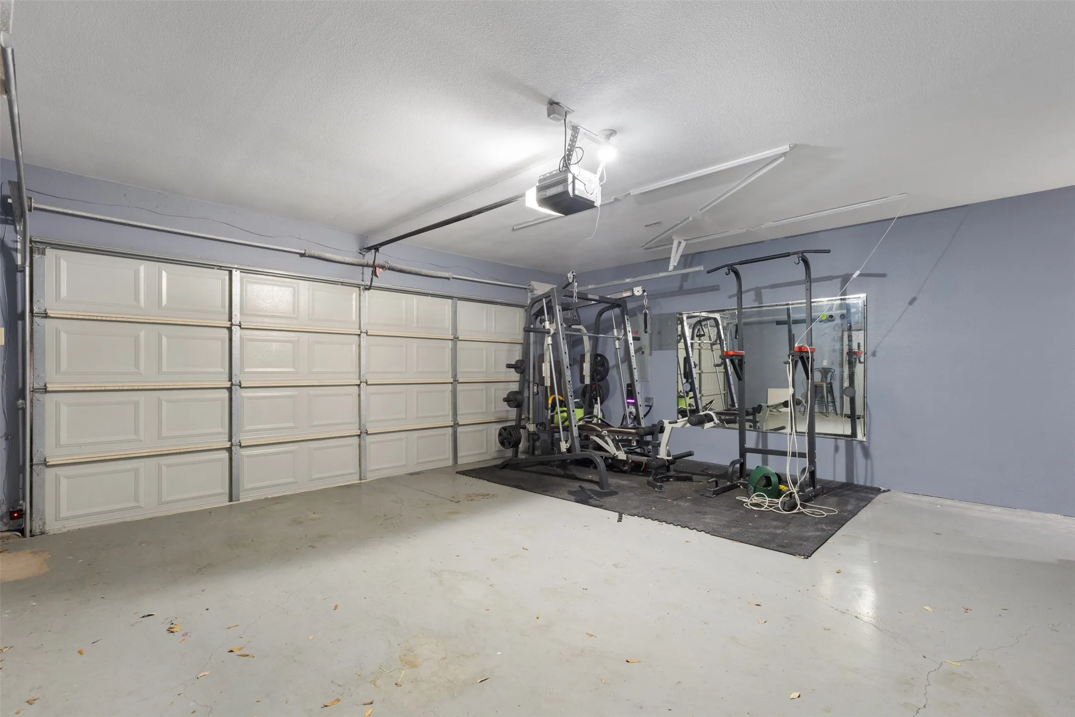 Two car garage with work-out area.