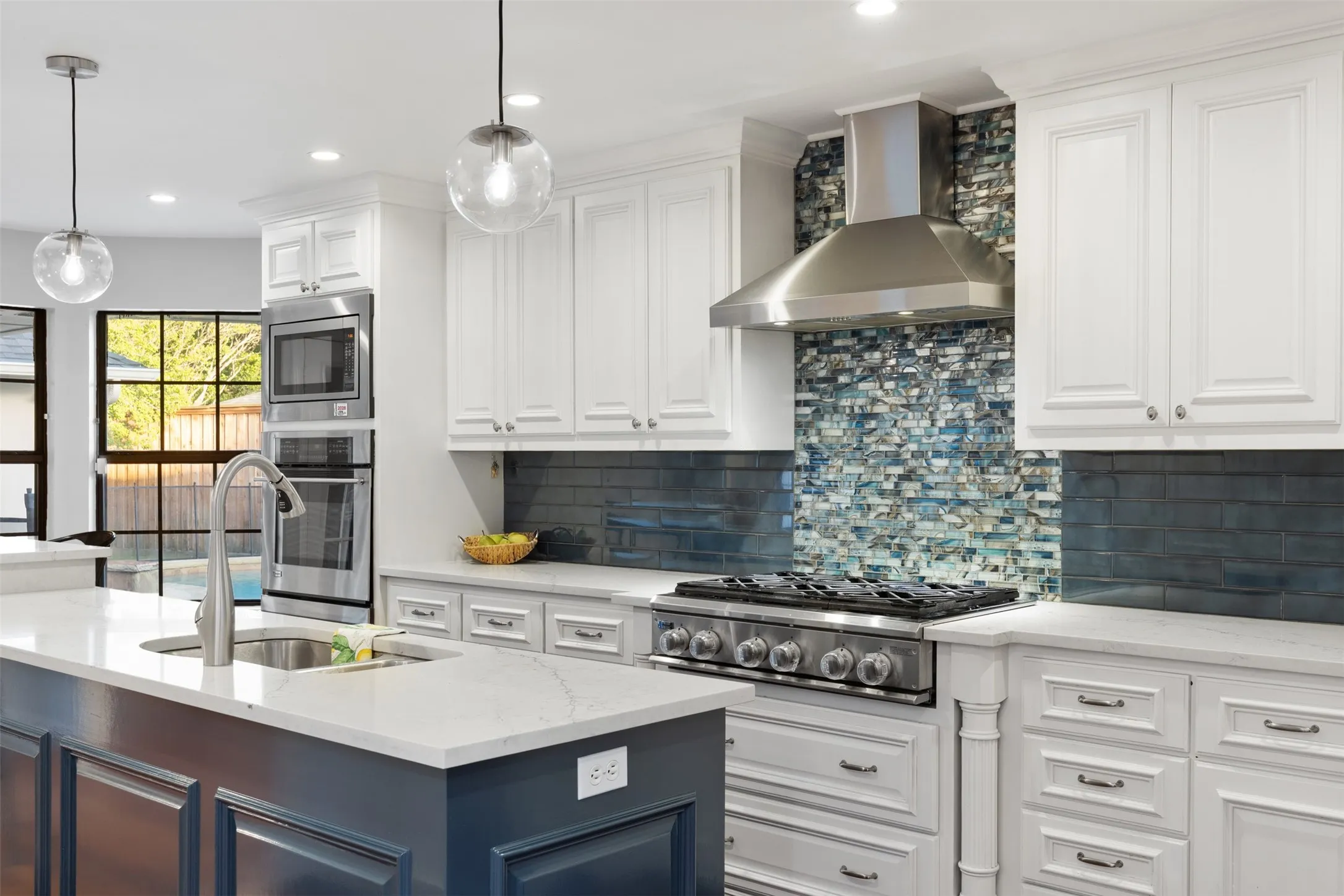 Close-up of cabinets, counter tops, appliances and fabulous back splash.