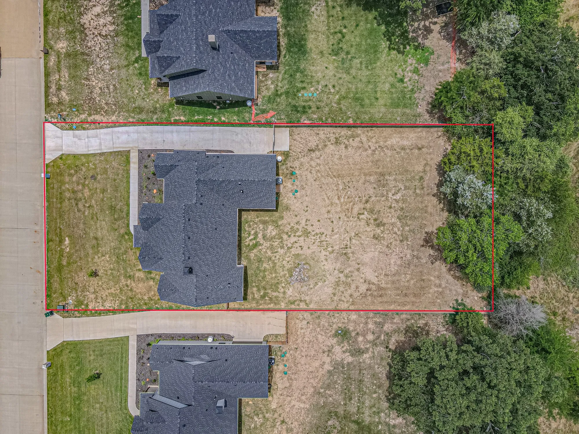 Expansive undeveloped lot with partial mature tree coverage