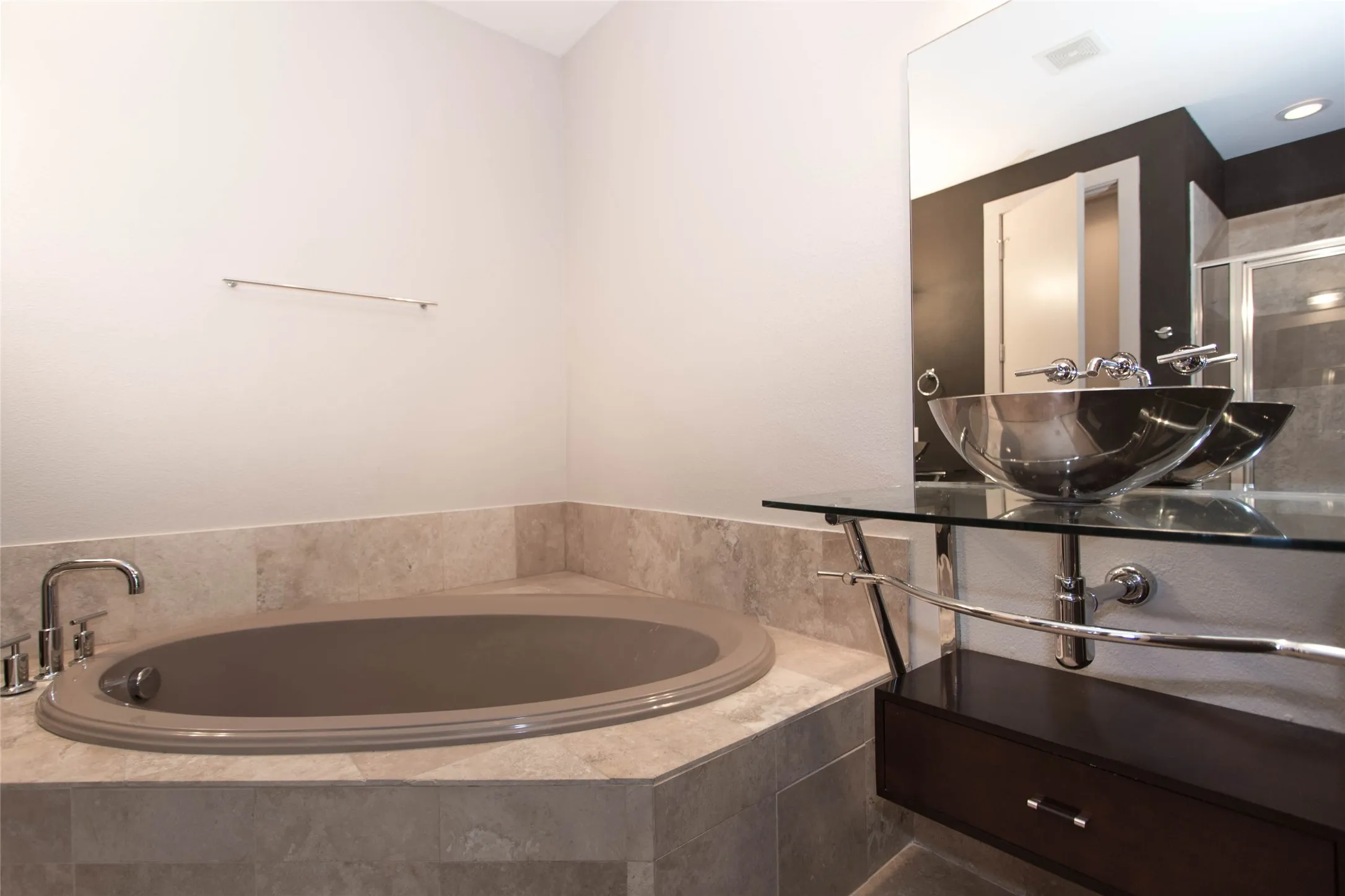 Oversized primary bathroom with stand up shower and separate bathtub