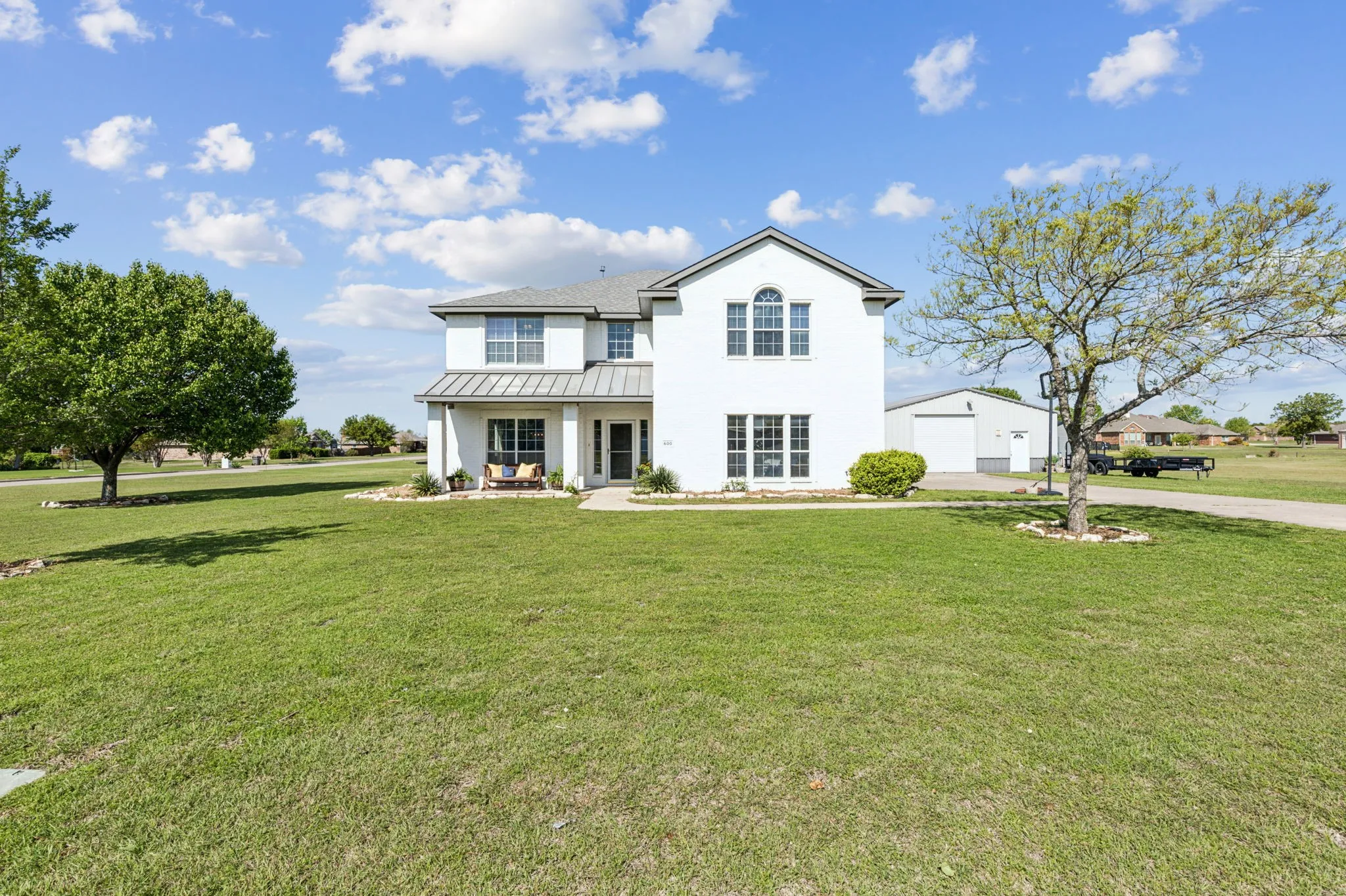 Enjoy a stunning front yard and covered front patio!