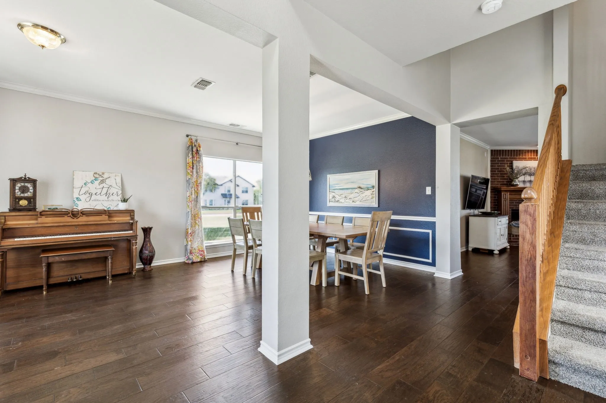 View as you walk in the front door. Notice the hardwood entry and hardwood flooring in the dining space and throughout most of the first level of the home