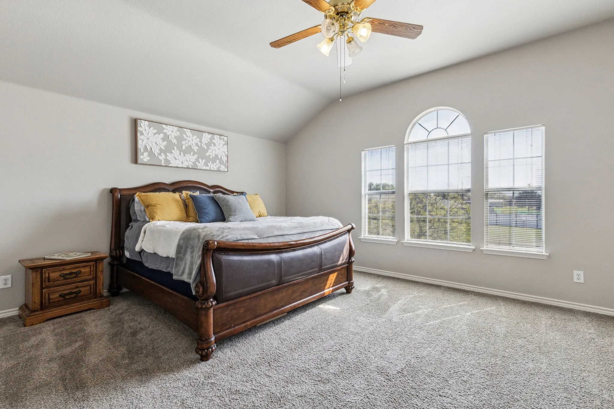 Large primary suite with views of stunning front yard.