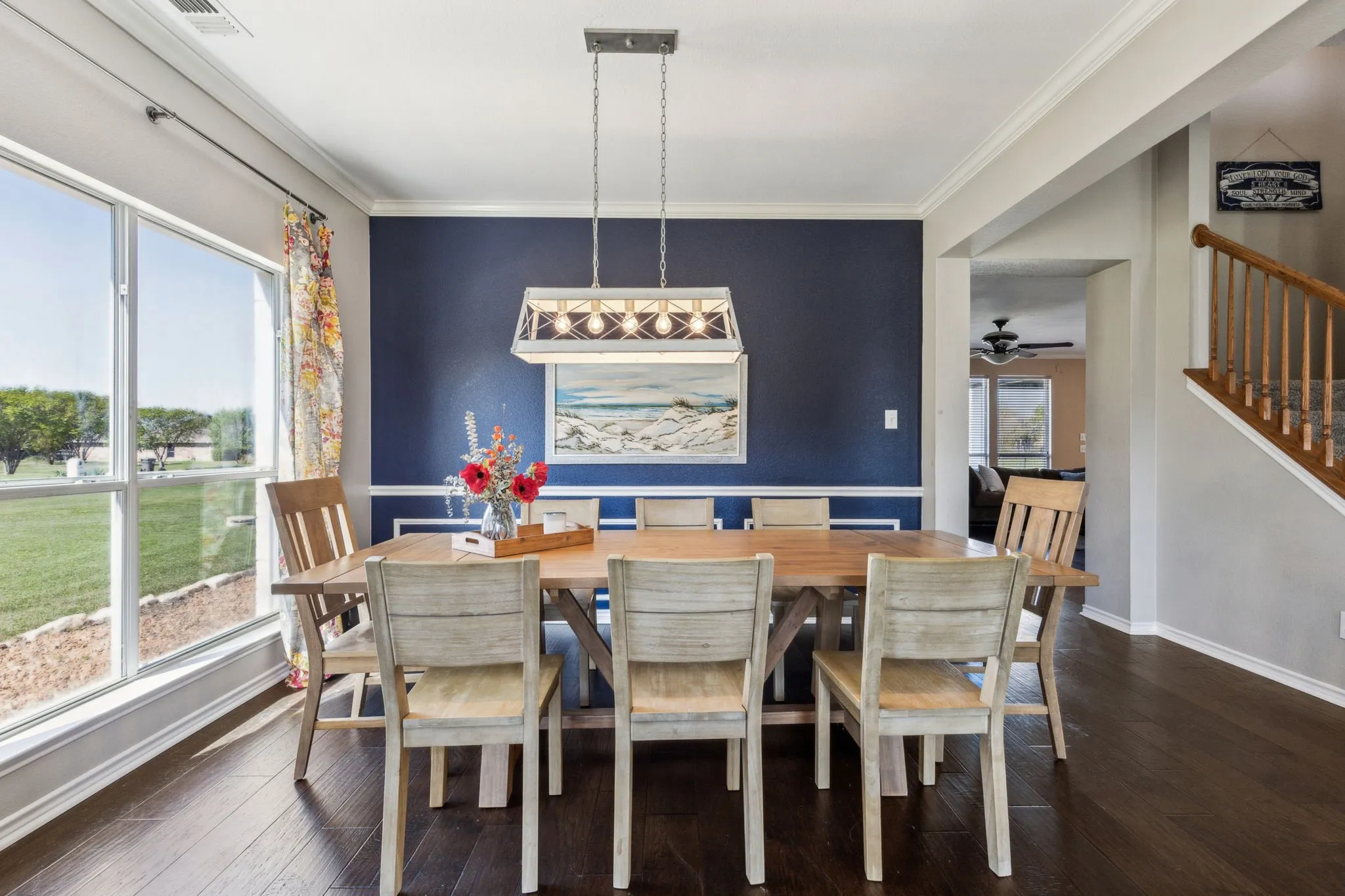 Dining room with amazing natural light, wainscoting and beautiful hardwood floors.