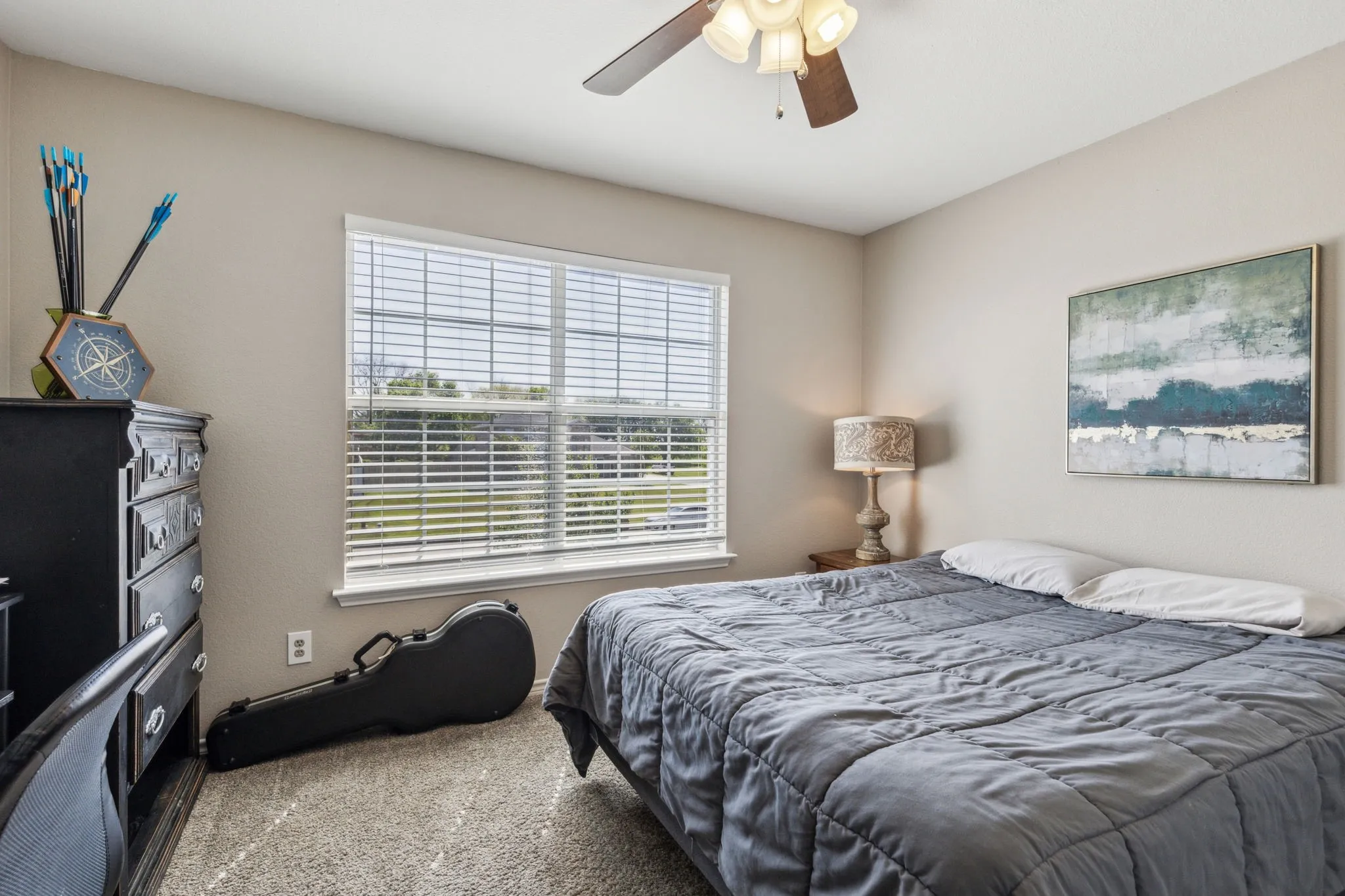 First bedroom has ceiling fan, capret, and double door closet with nice space.