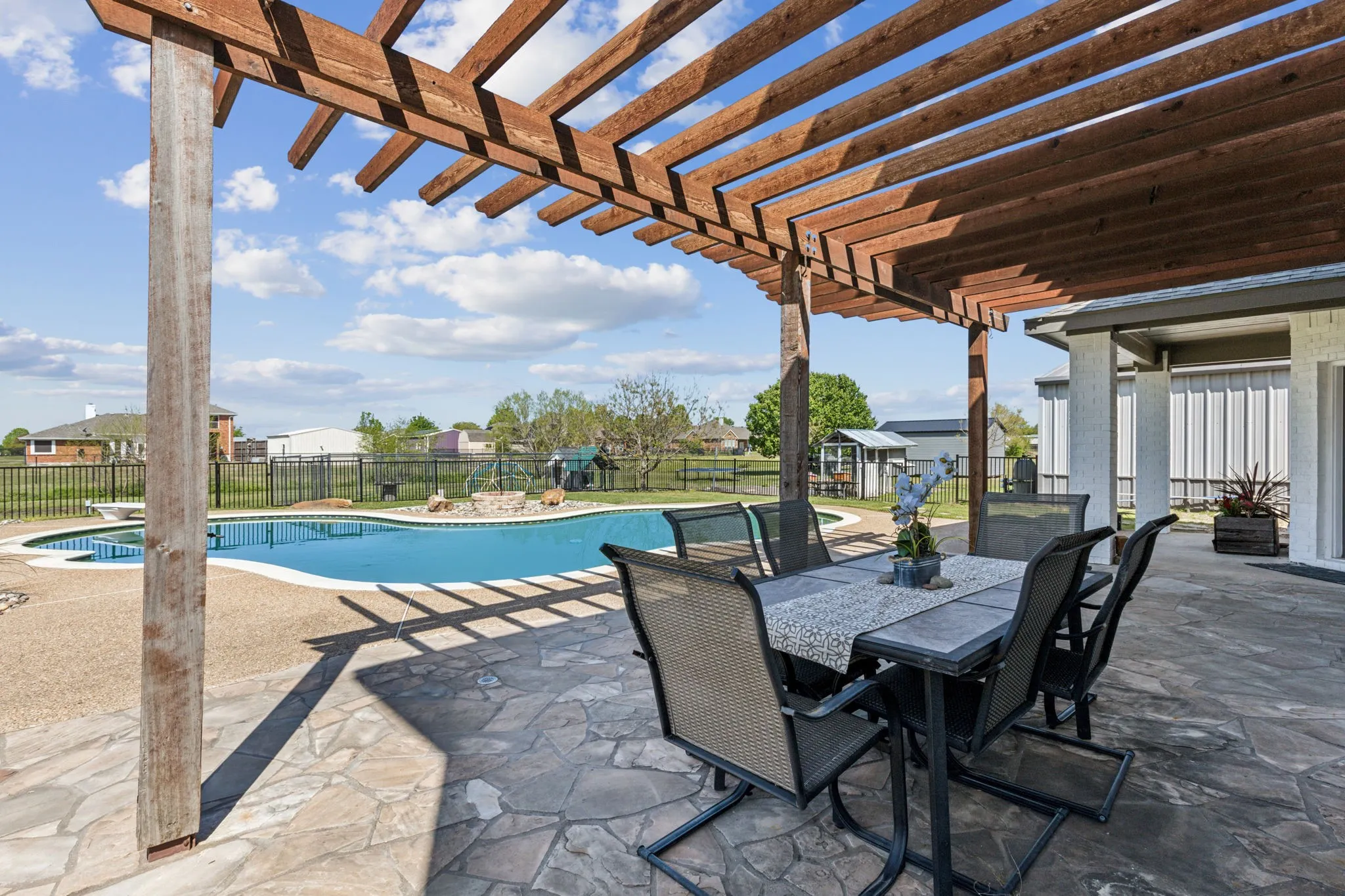View into gorgeous backyard from pergola!
