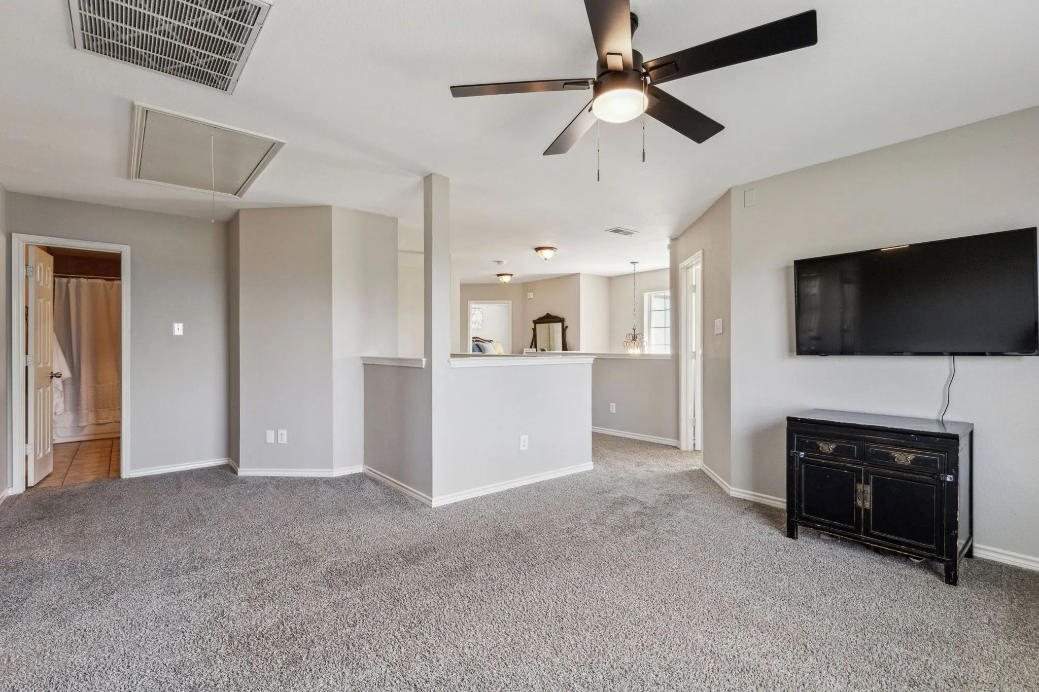 Another view of game room looking toward the primary suite and secondary bath.