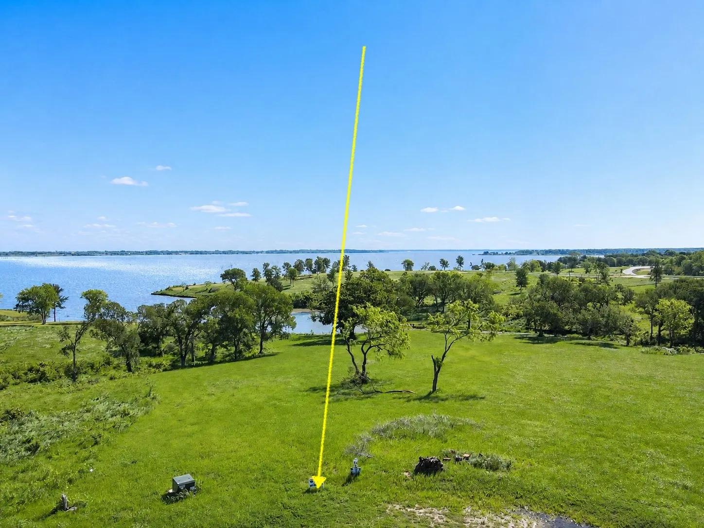 yellow arrow points to Lot 53’s open homesite and lakefront setting.