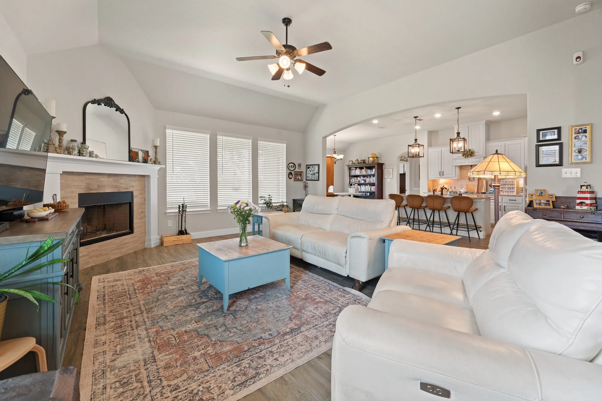 Living room featuring vaulted ceilings and wood-finish flooring