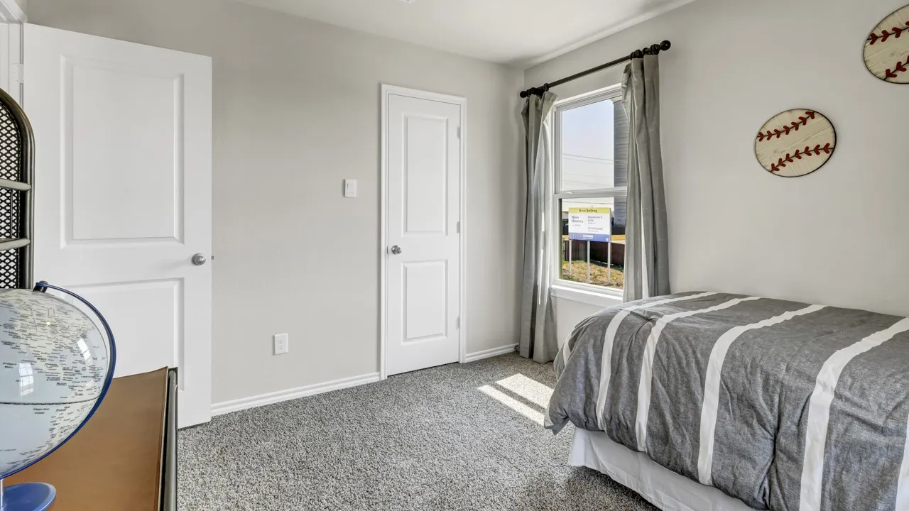 Carpeted room featuring multiple panel doors, a large window with drapes, and neutral wall paint